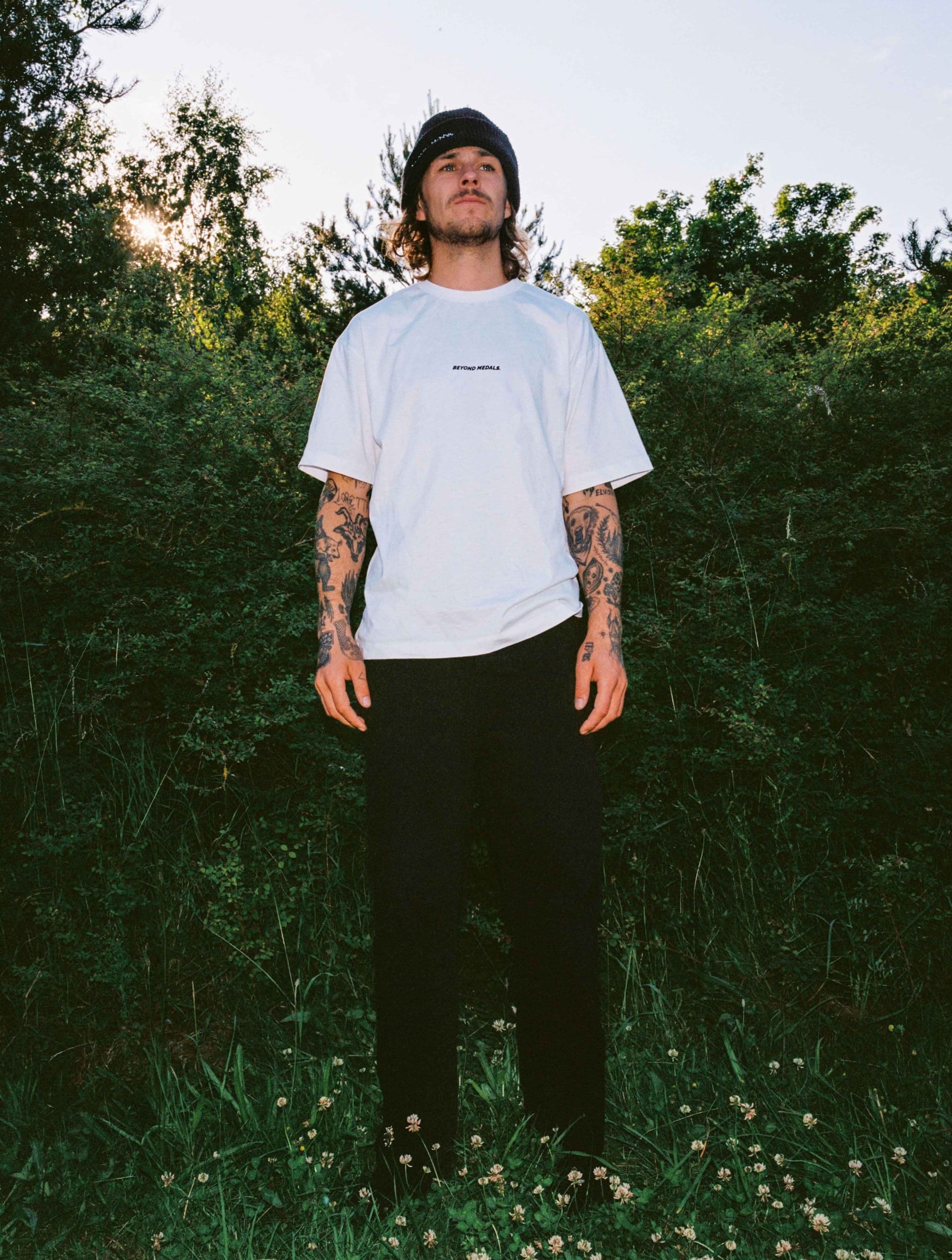 Streetwear clothing, baekkel tee in white worn by KEVIN BAEKKEL, Beyond Medals, 2024, front