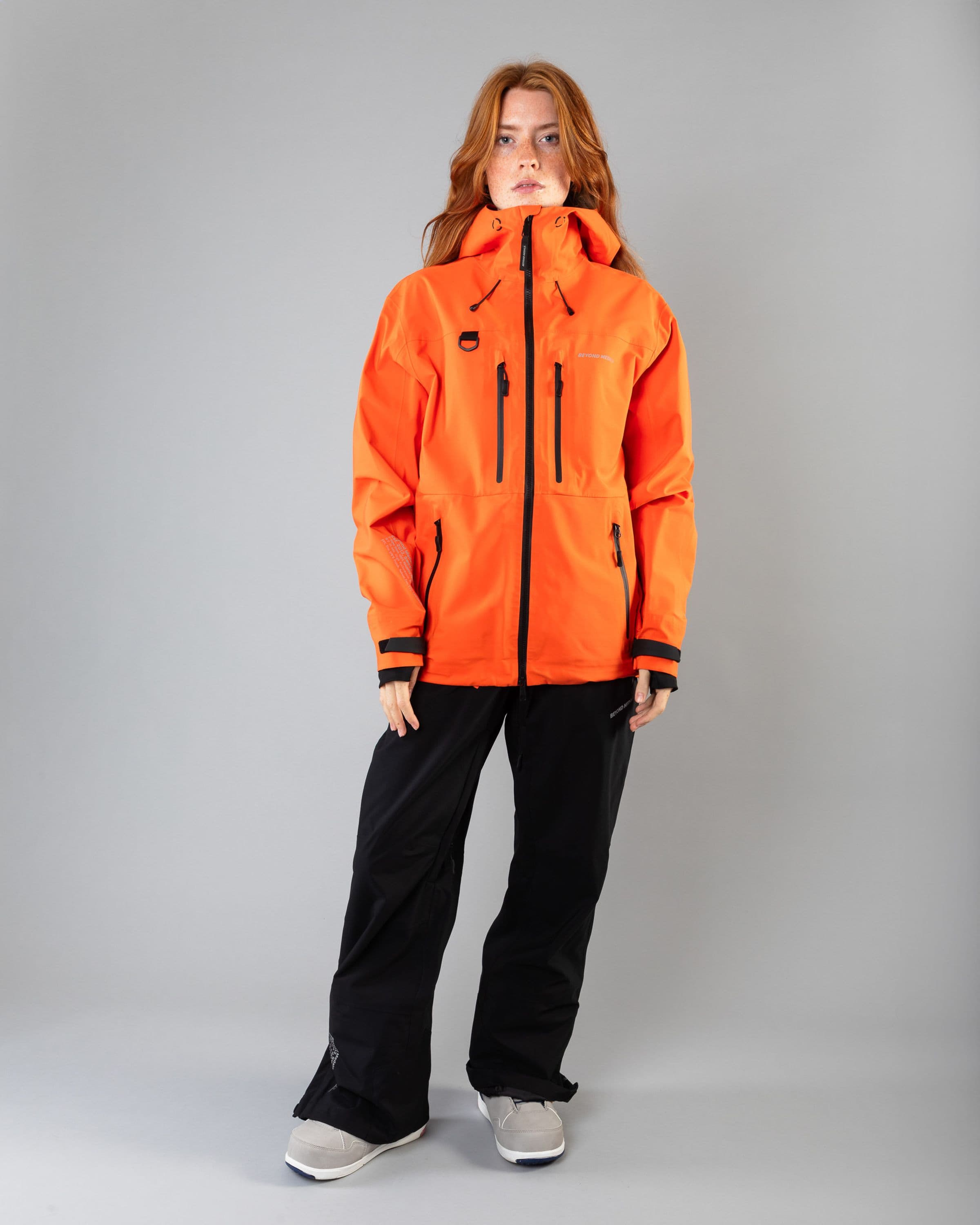 Outerwear clothing, pro tech jacket 3l in orange worn by model, Beyond Medals, 2024, full front