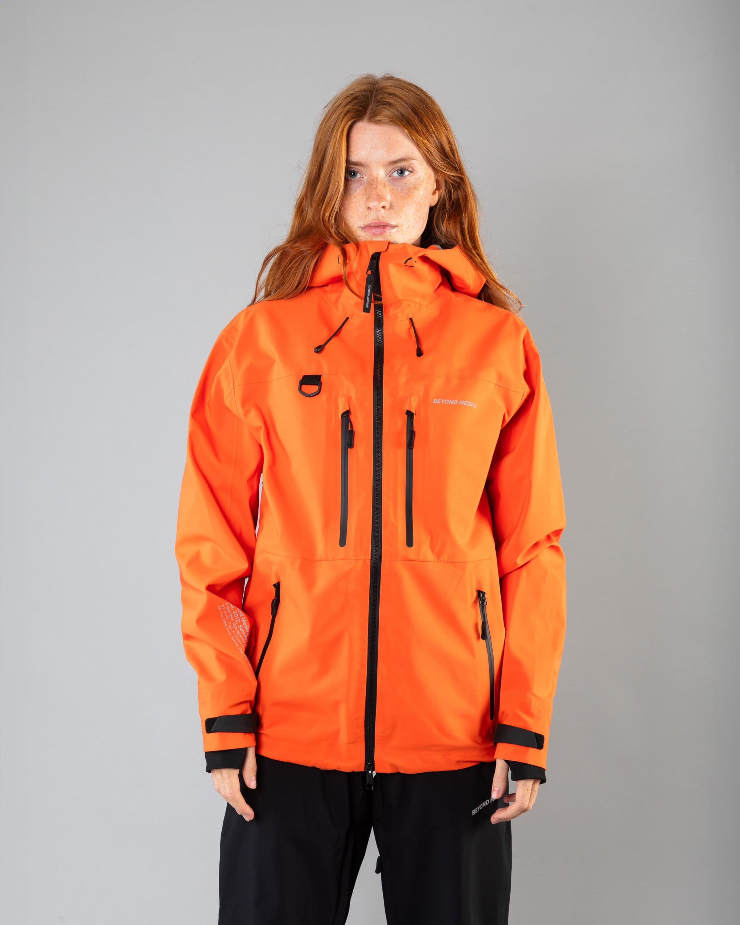 Outerwear clothing, pro tech jacket 3l in orange worn by model, Beyond Medals, 2024, front