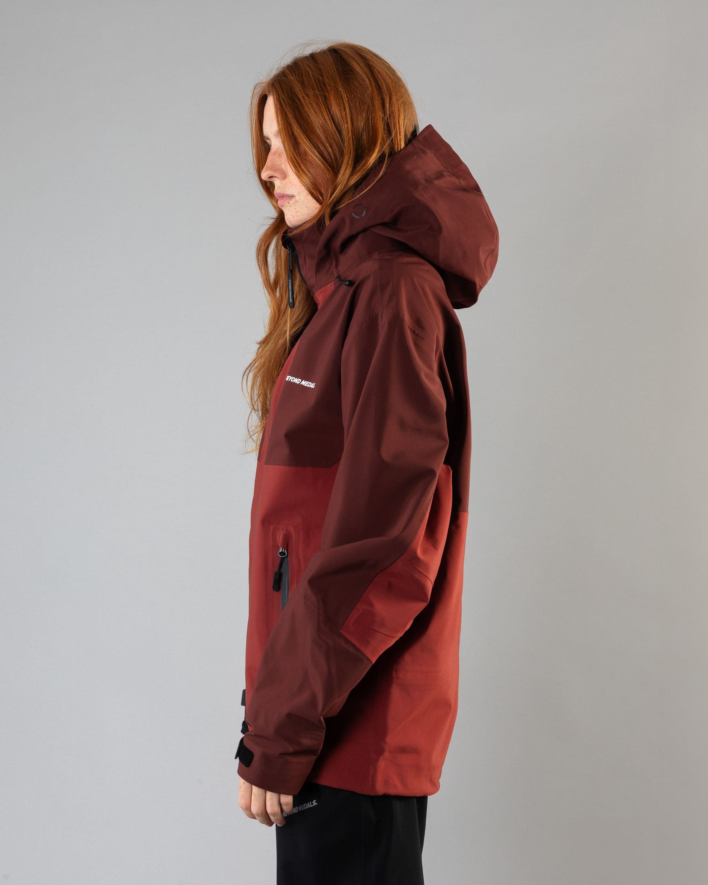 Outerwear clothing, tech jacket 3l in red worn by model, Beyond Medals, 2024, side