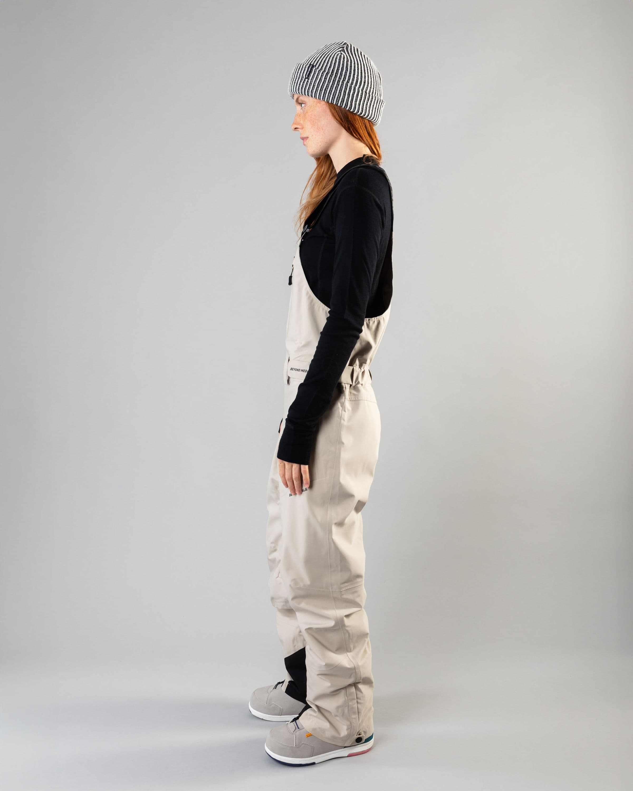 Outerwear clothing, tech bib 3l in lt beige worn by model, Beyond Medals, 2024, side