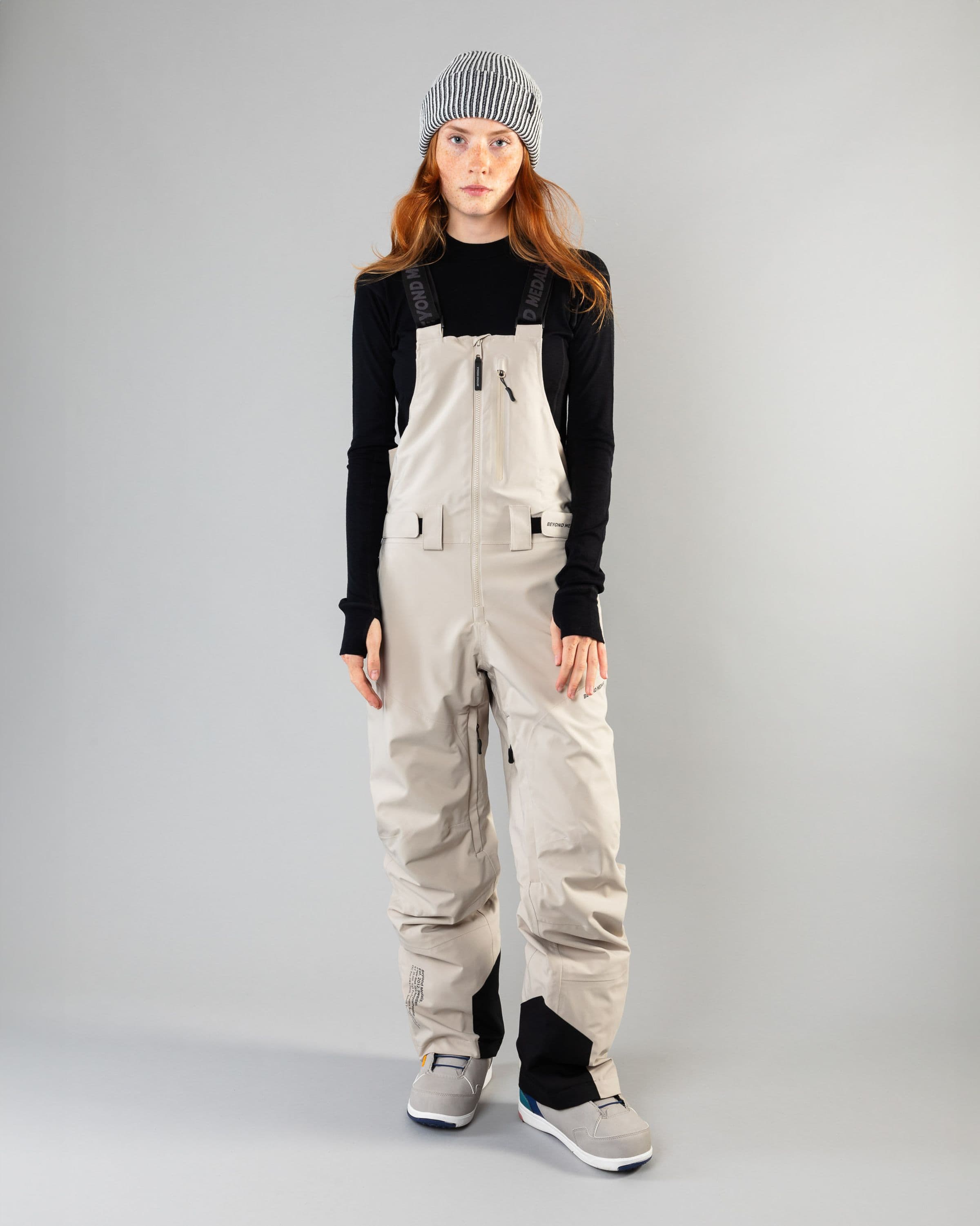 Outerwear clothing, tech bib 3l in lt beige worn by model, Beyond Medals, 2024, front