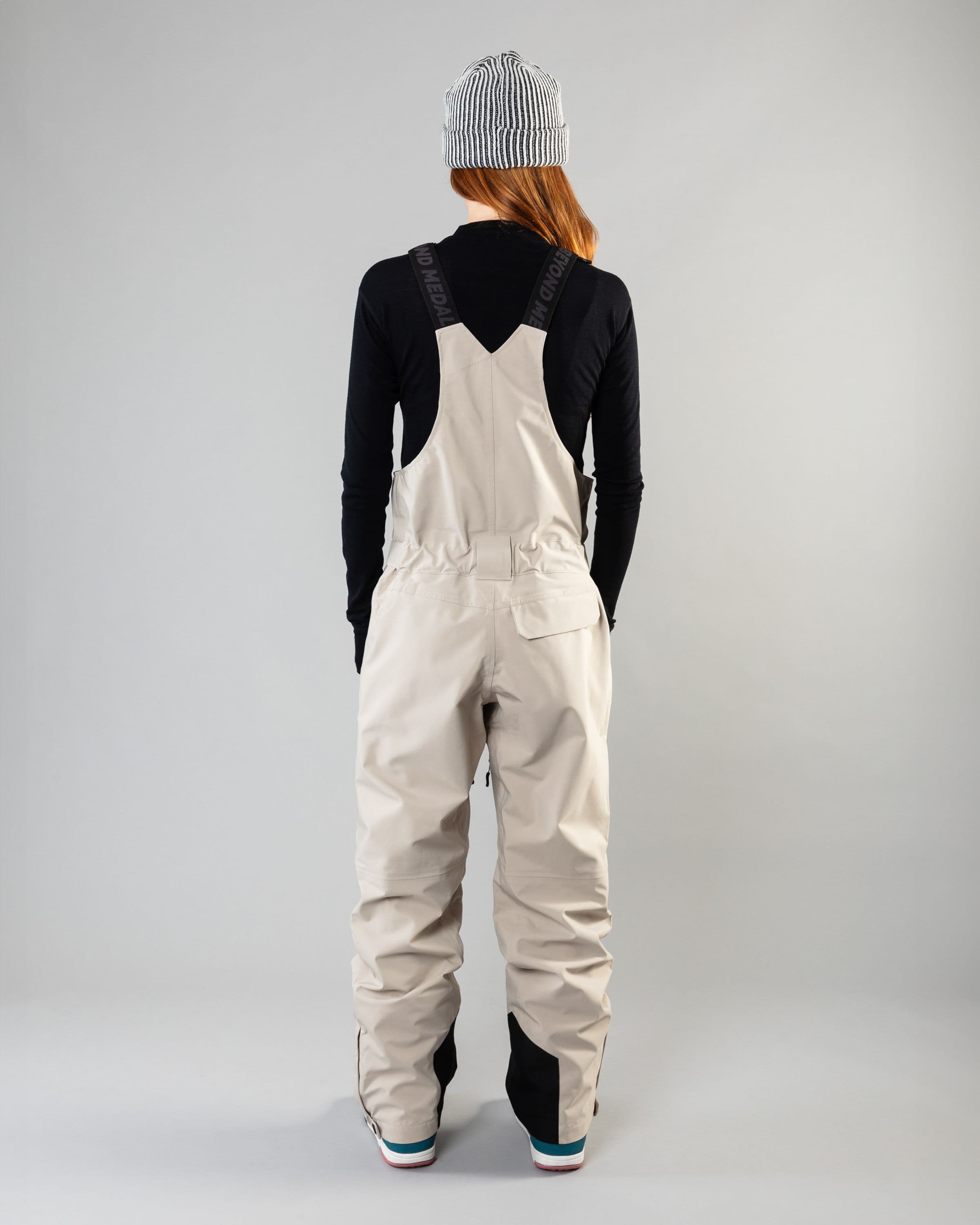 Outerwear clothing, tech bib 3l in lt beige worn by model, Beyond Medals, 2024, back