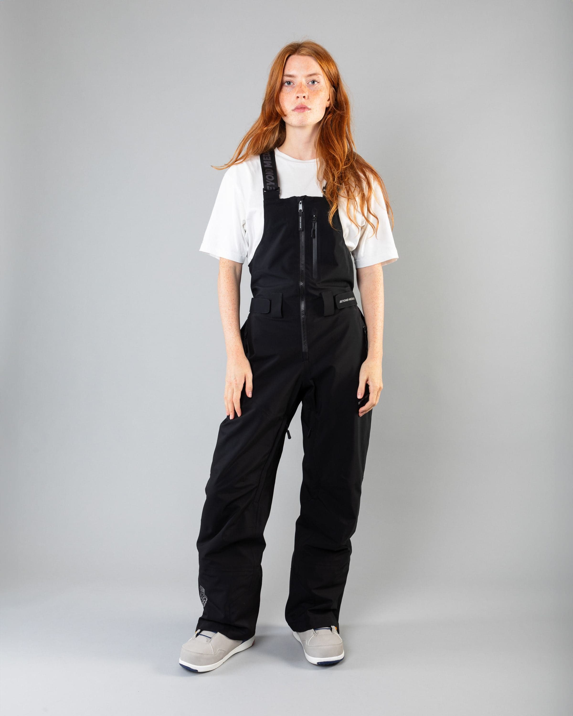 Outerwear clothing, tech bib 3l in black worn by model, Beyond Medals, 2024, front