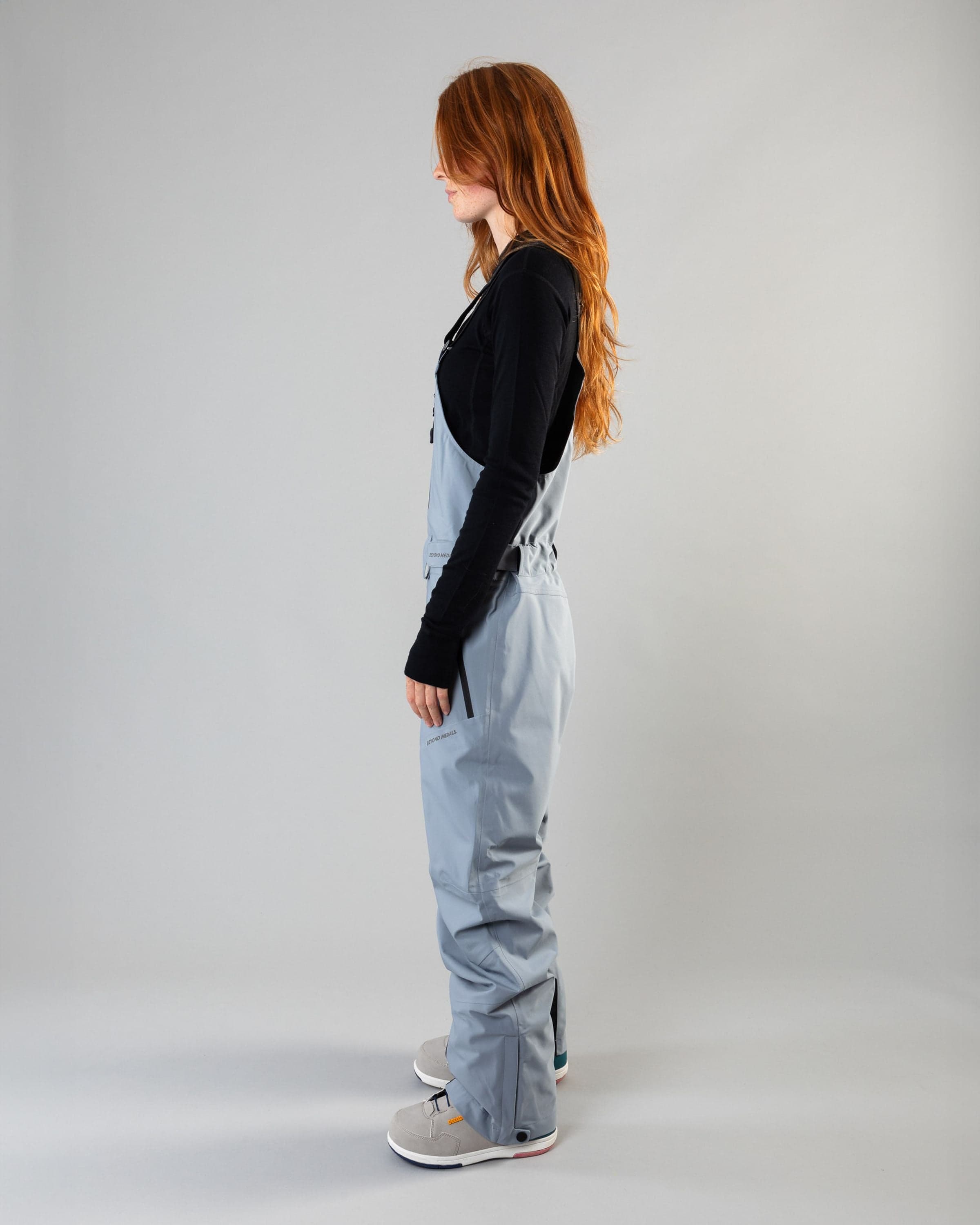 Outerwear clothing, tech bib 3l in pale blue worn by model, Beyond Medals, 2024, side