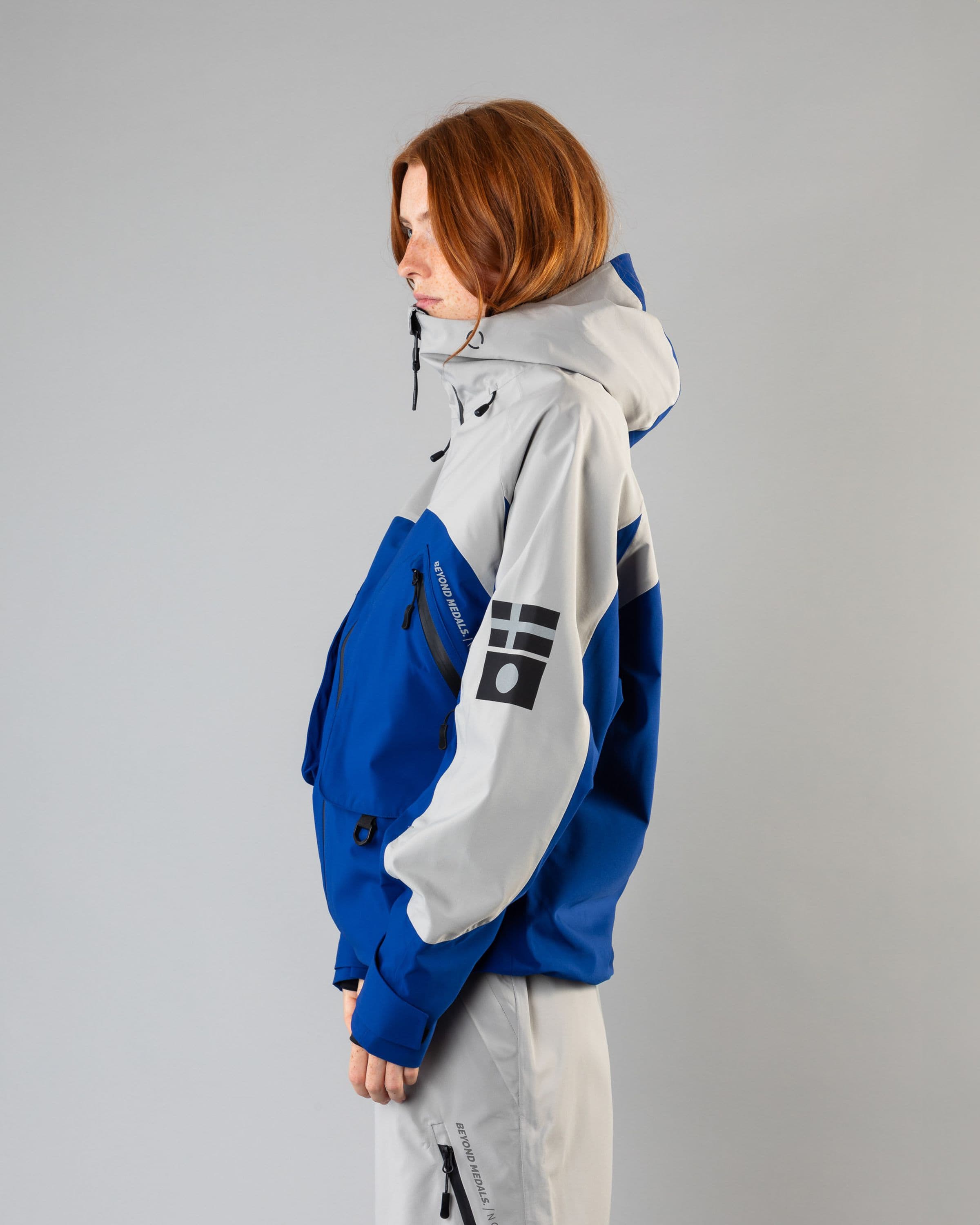 Outerwear clothing, beyond medals x nomadik jacket 3l in blue worn by model, Beyond Medals, 2024, side