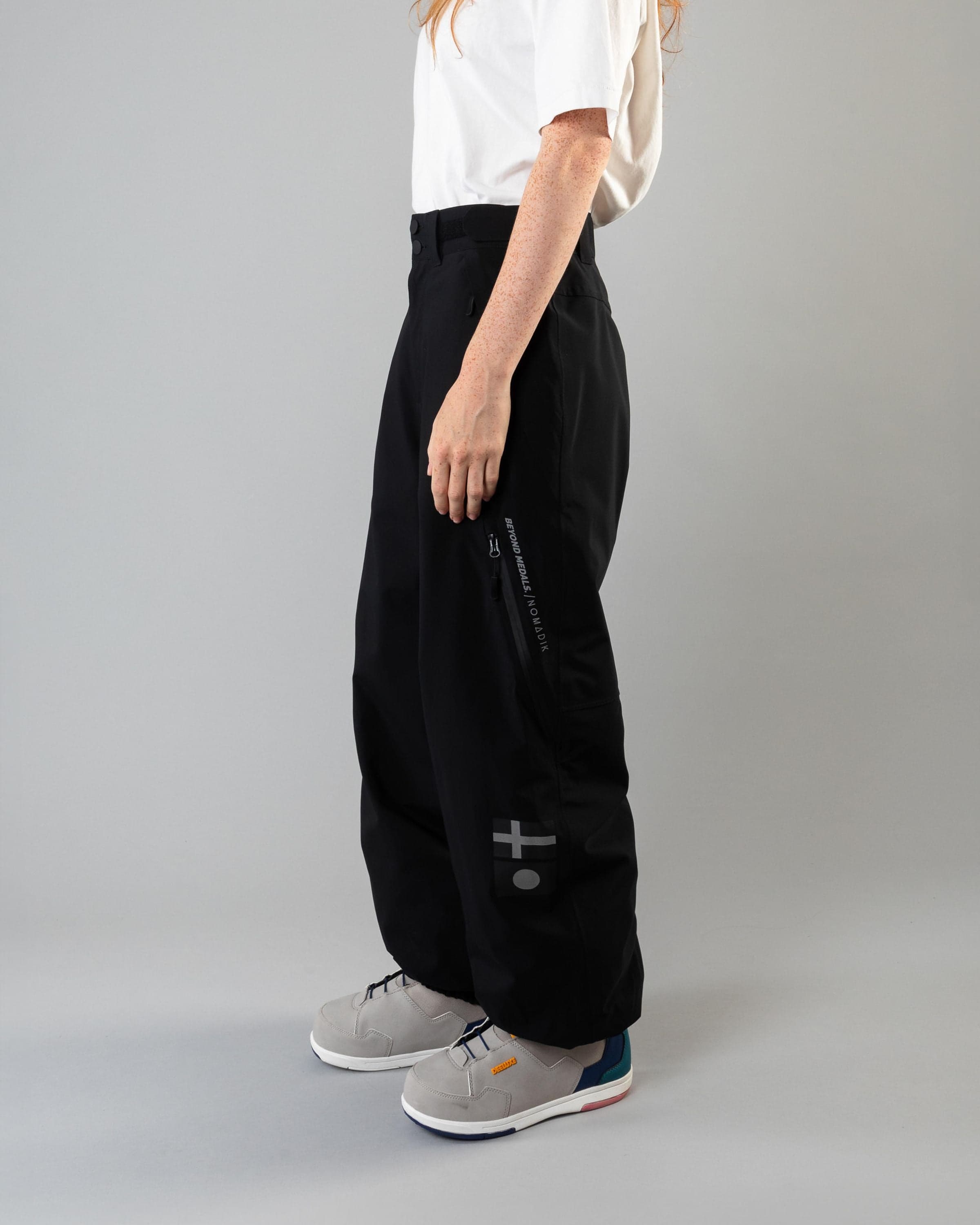 Outerwear clothing, beyond medals x nomadik pants 3l in black worn by model, Beyond Medals, 2024, side
