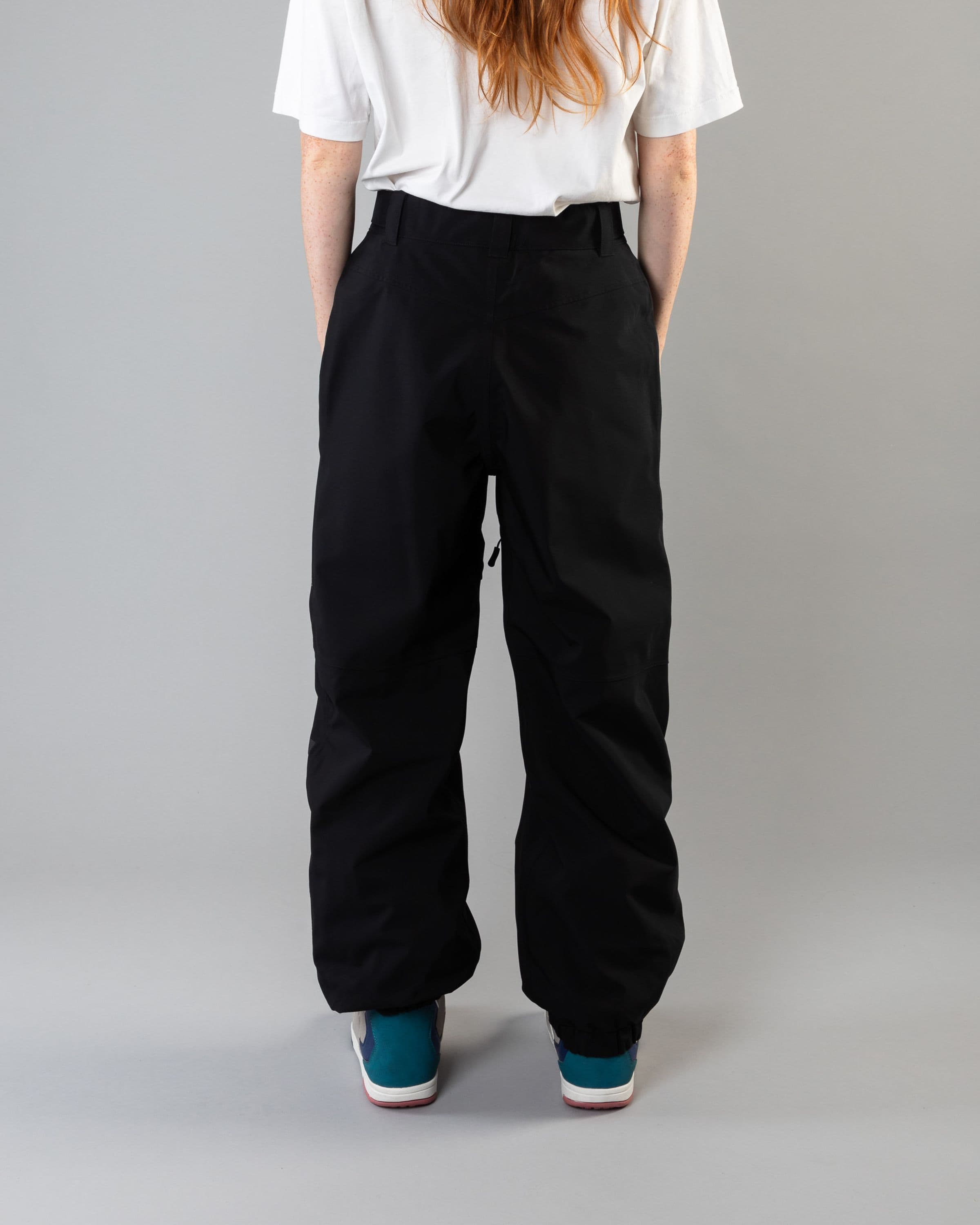 Outerwear clothing, beyond medals x nomadik pants 3l in black worn by model, Beyond Medals, 2024, back