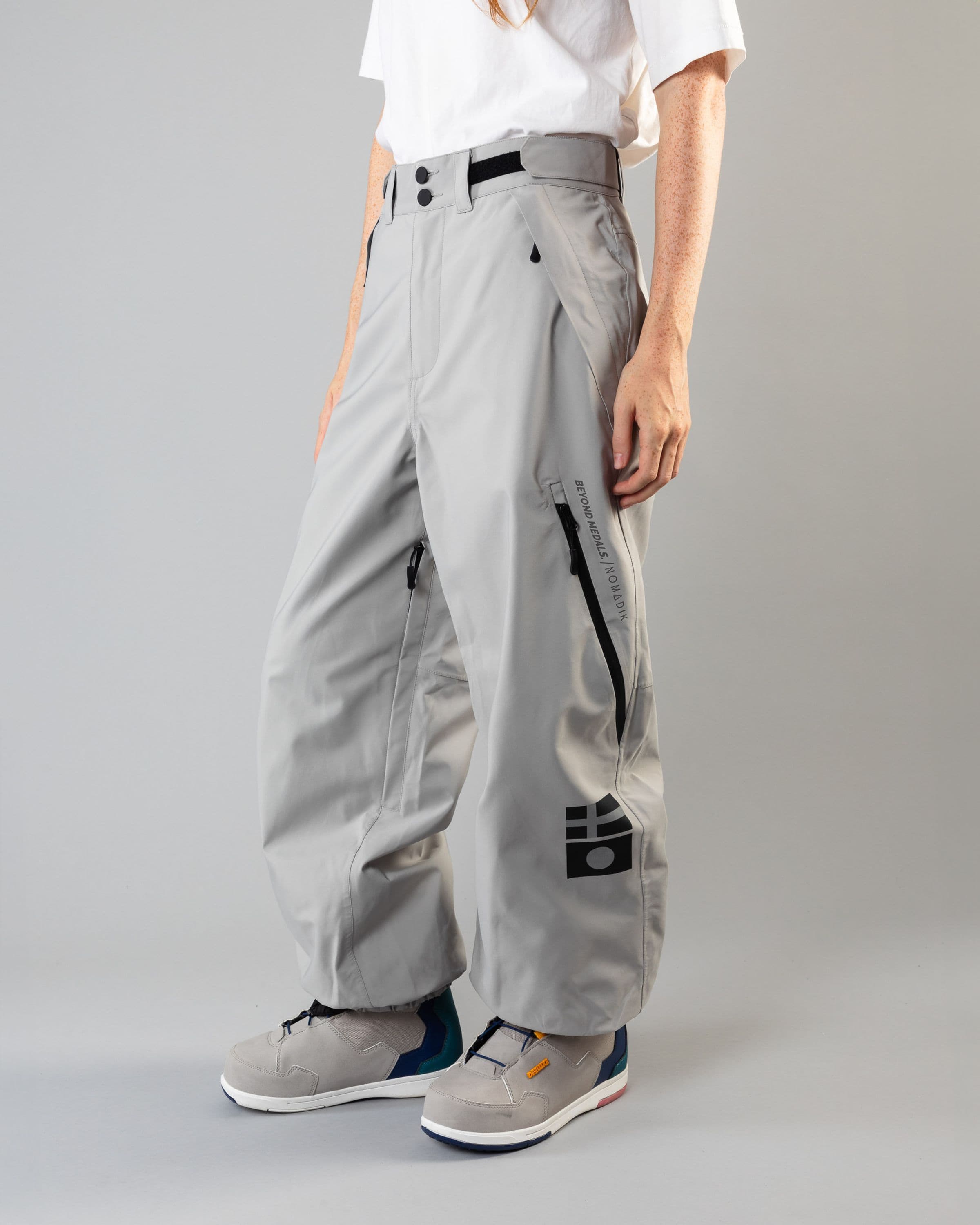 Outerwear clothing, beyond medals x nomadik pants 3l in grey worn by model, Beyond Medals, 2024, front