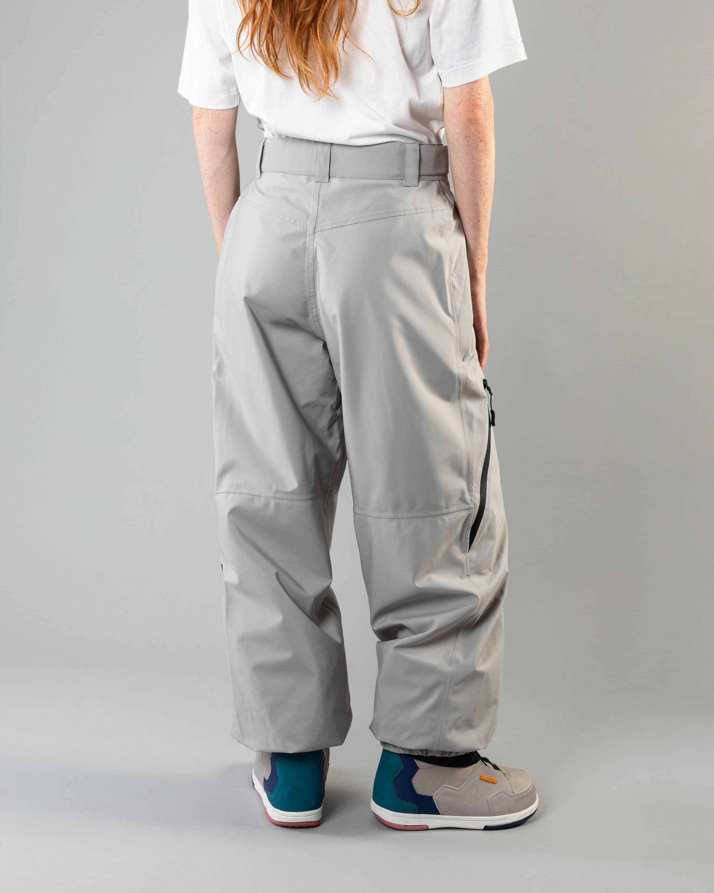 Outerwear clothing, beyond medals x nomadik pants 3l in grey worn by model, Beyond Medals, 2024, back