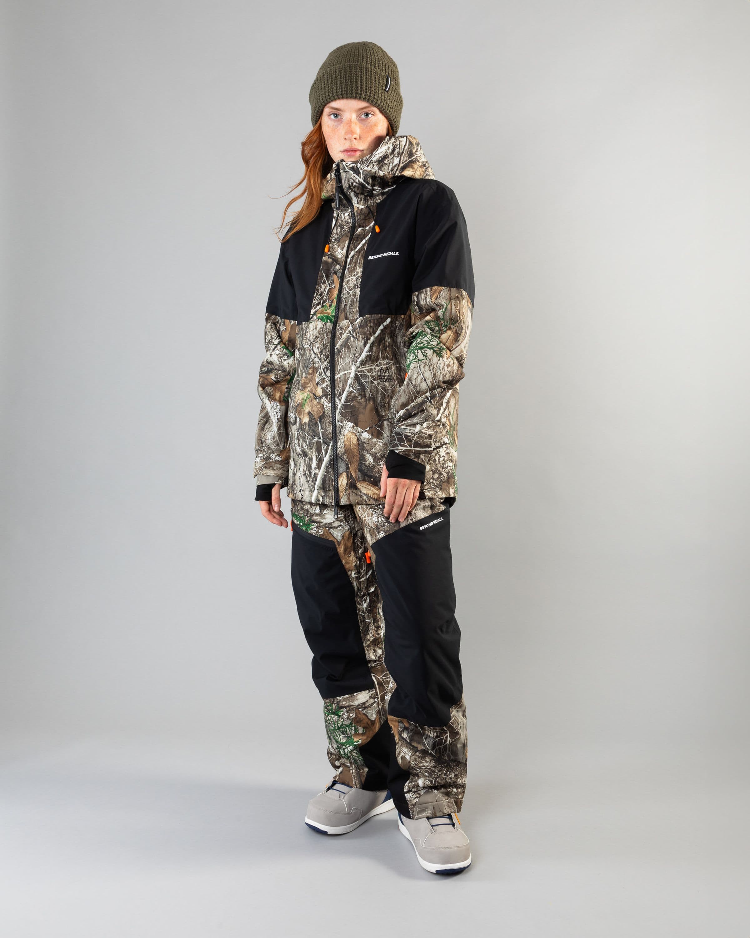 Outerwear clothing, zip pants 2l in realtree worn by model, Beyond Medals, 2024, fullfront1