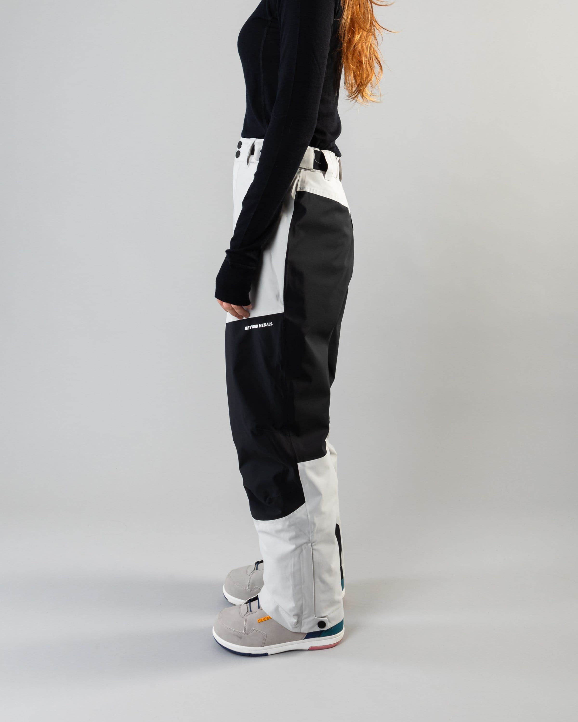 Outerwear clothing, zip pants 2l in grey worn by model, Beyond Medals, 2024, side