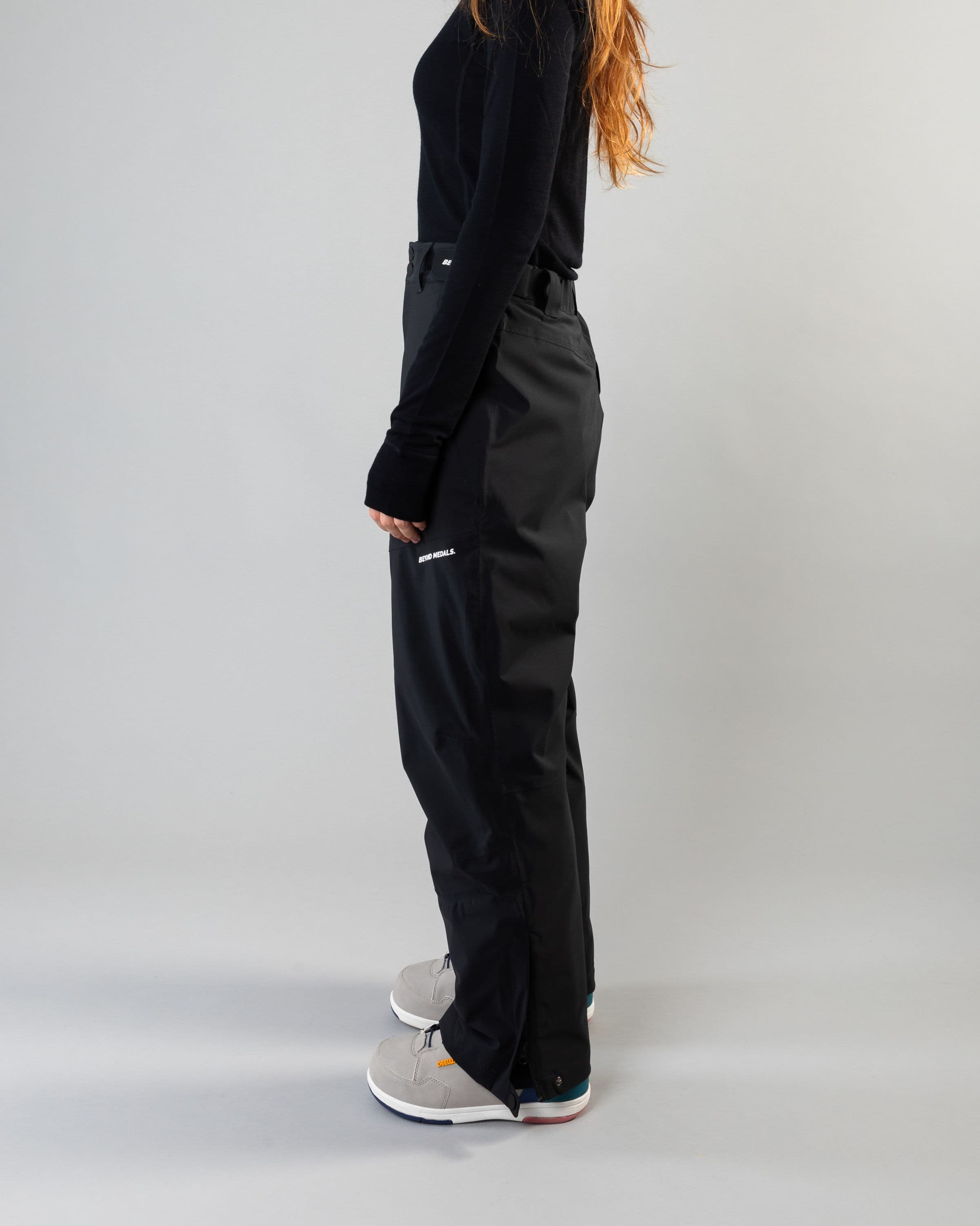 Outerwear clothing, zip pants 2l in black worn by model, Beyond Medals, 2024, side