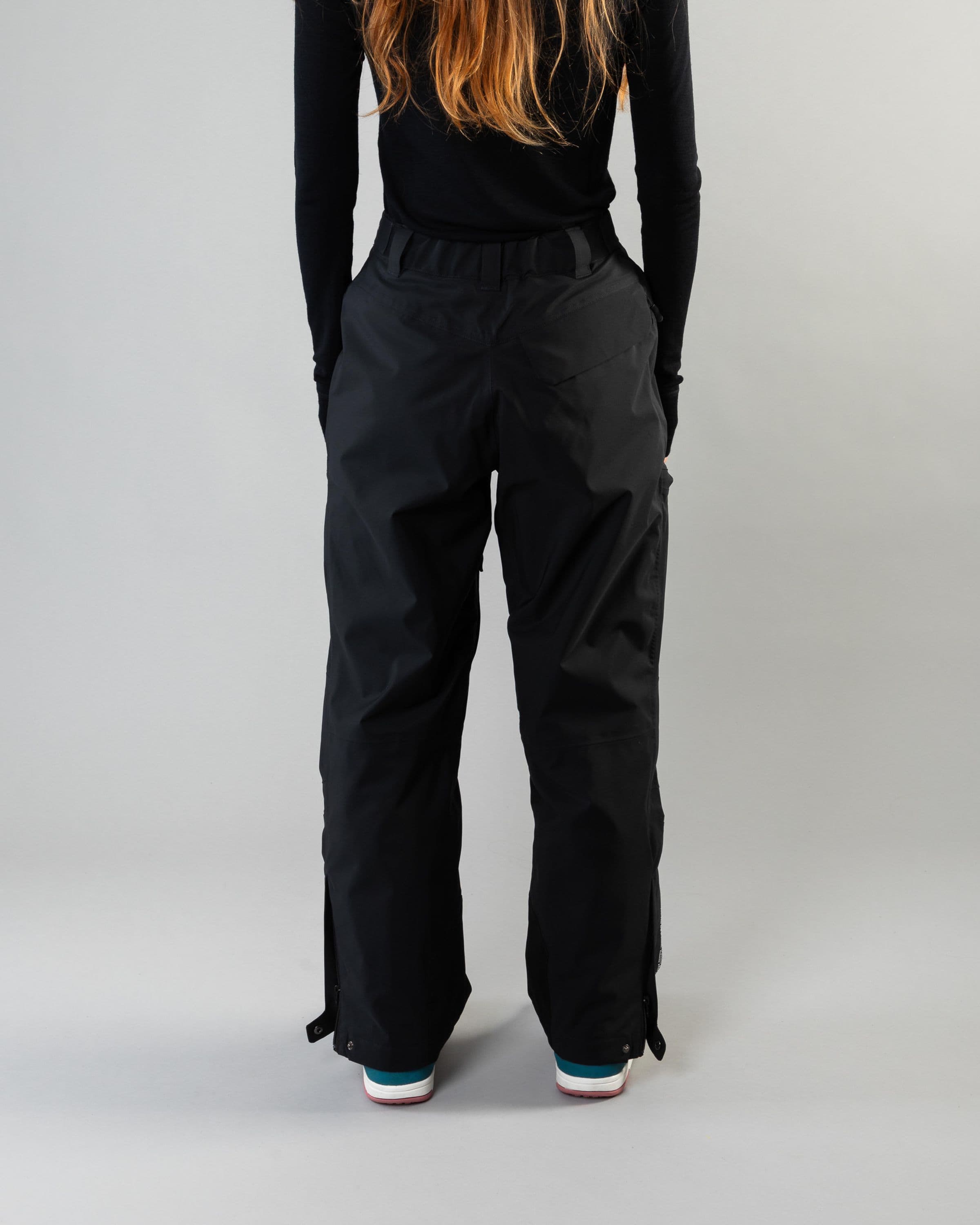 Outerwear clothing, zip pants 2l in black worn by model, Beyond Medals, 2024, back