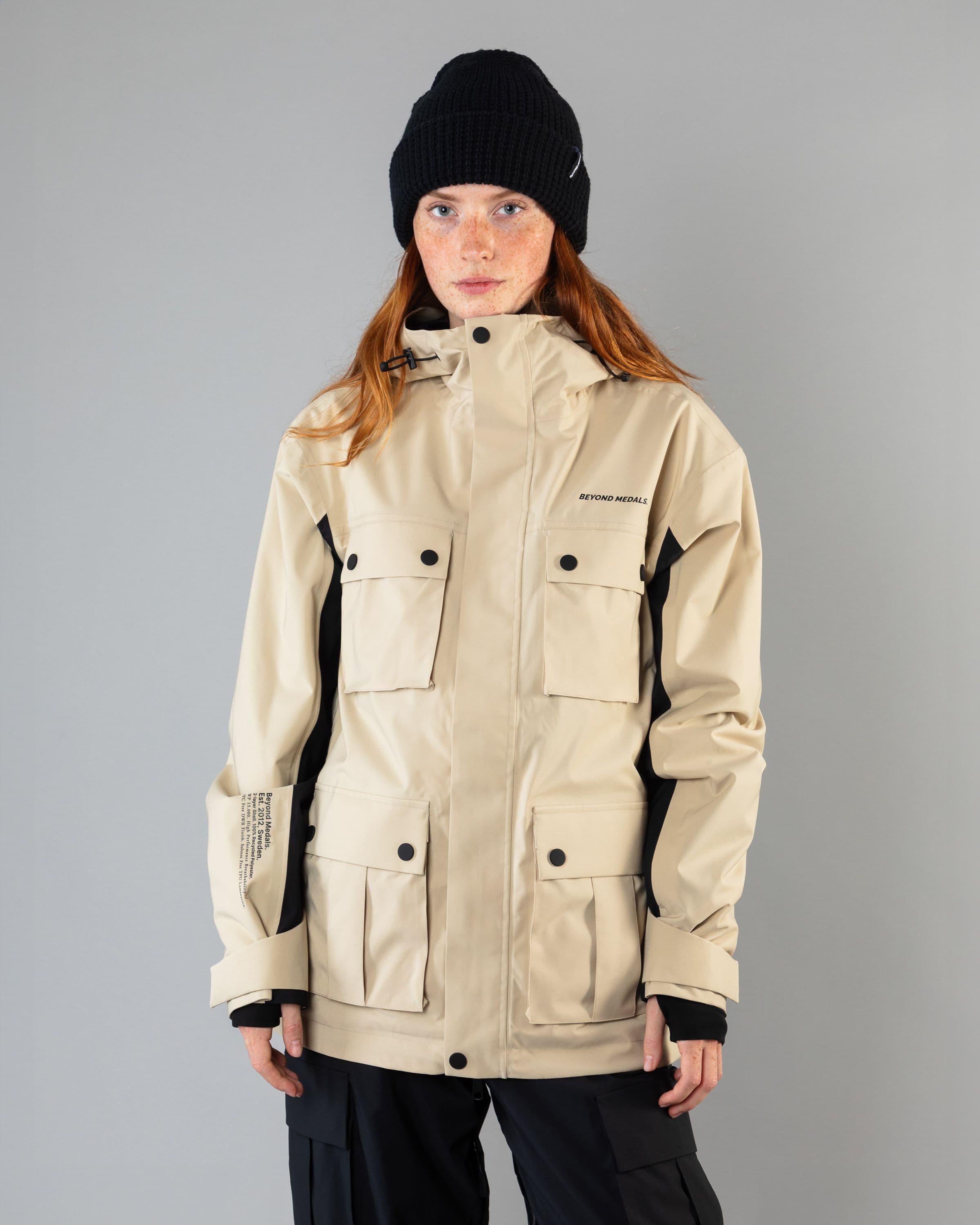 Outerwear clothing, cargo jacket 2l in beige worn by model, Beyond Medals, 2024, front