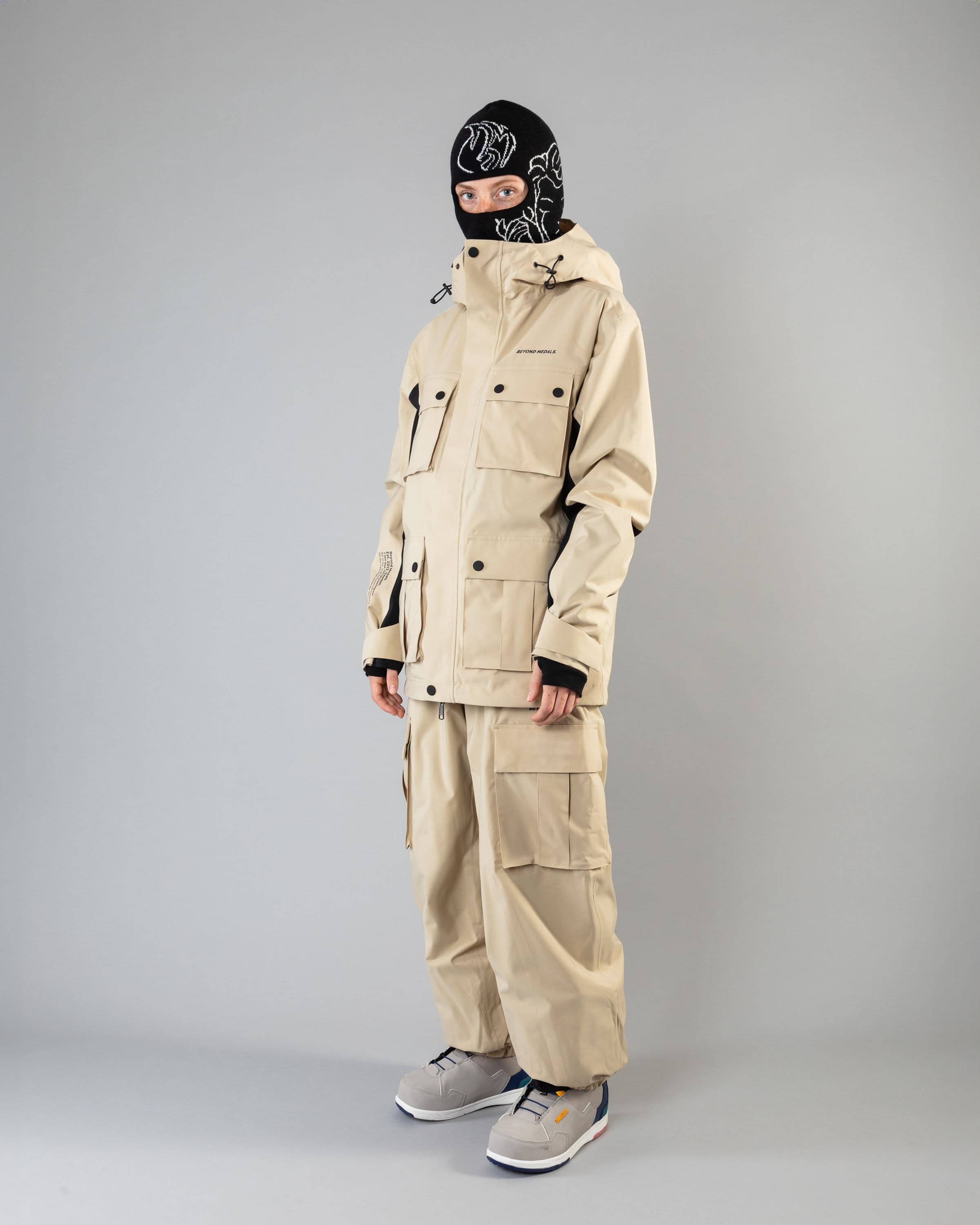 Outerwear clothing, cargo pants in beige worn by model, Beyond Medals, 2024, full front