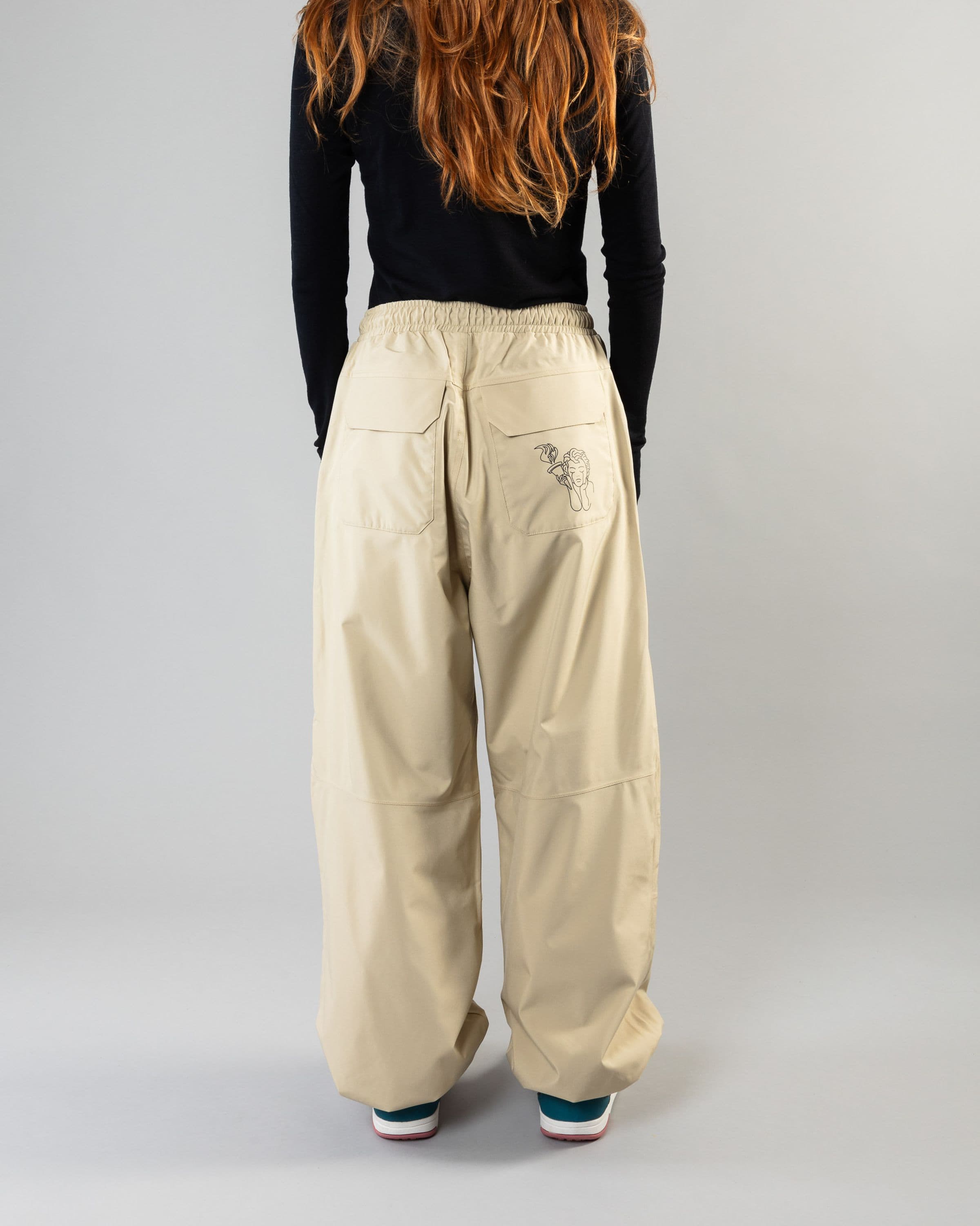 Outerwear clothing, park pants in beige worn by model, Beyond Medals, 2024, back