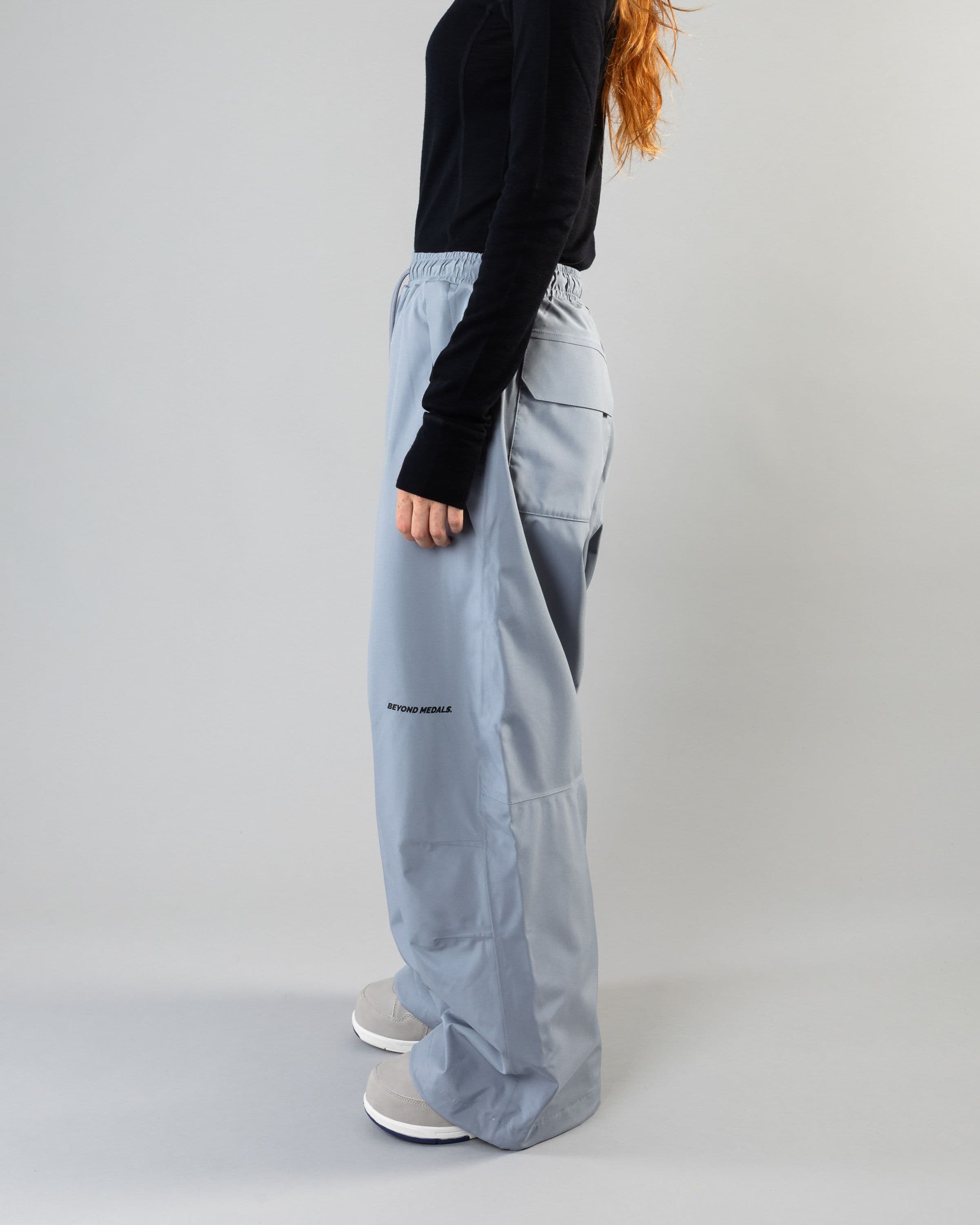 Outerwear clothing, park pants in pale blue worn by model, Beyond Medals, 2024, side