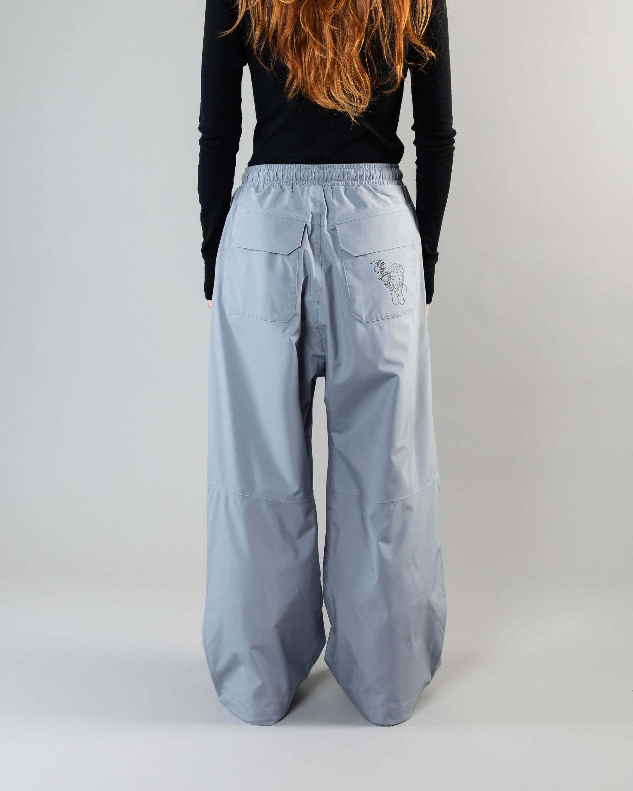 Outerwear clothing, park pants in pale blue worn by model, Beyond Medals, 2024, back