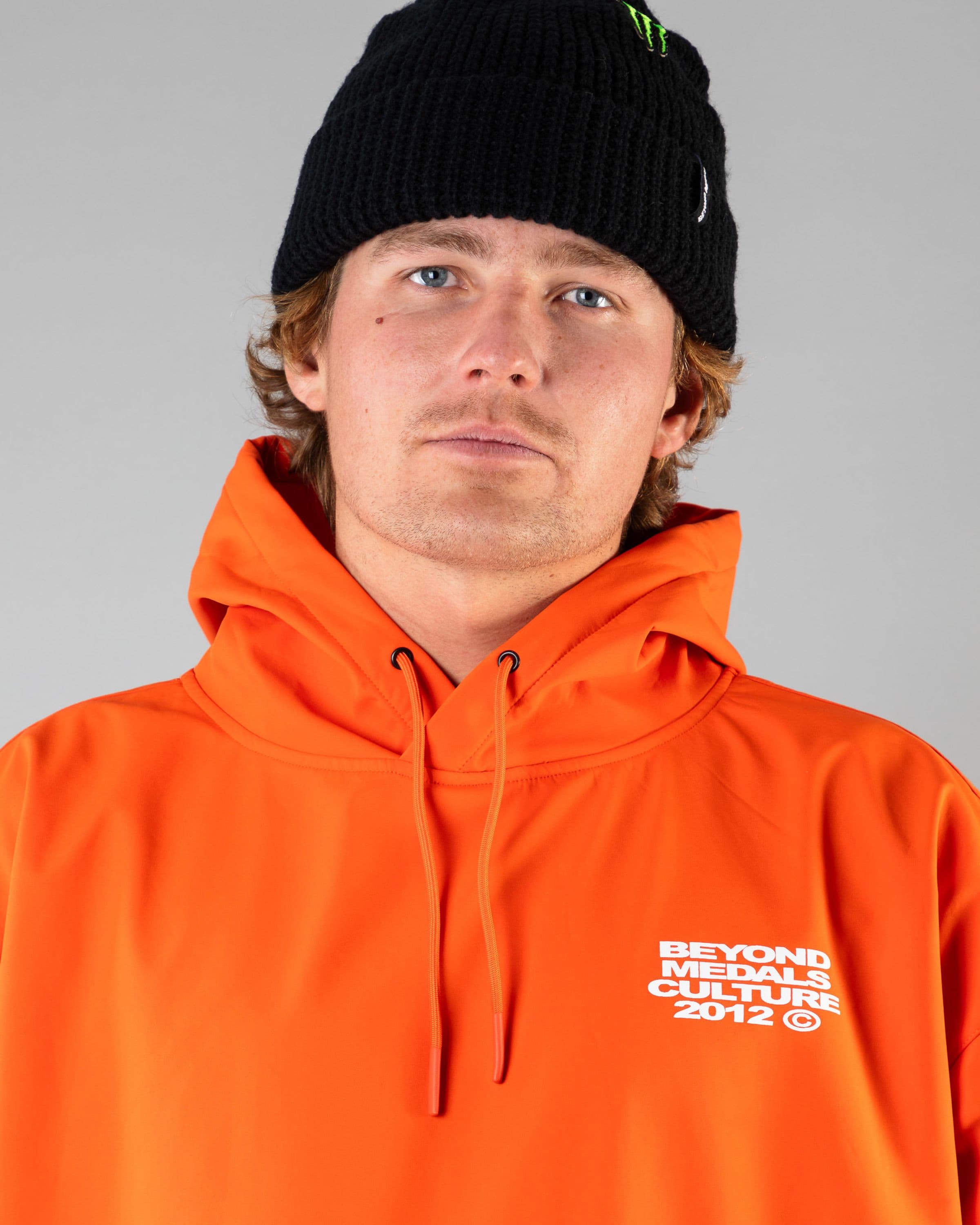 Outerwear clothing, softshell hoodie in orange worn by SEBBE DE BUCK, Beyond Medals, 2024, detail1