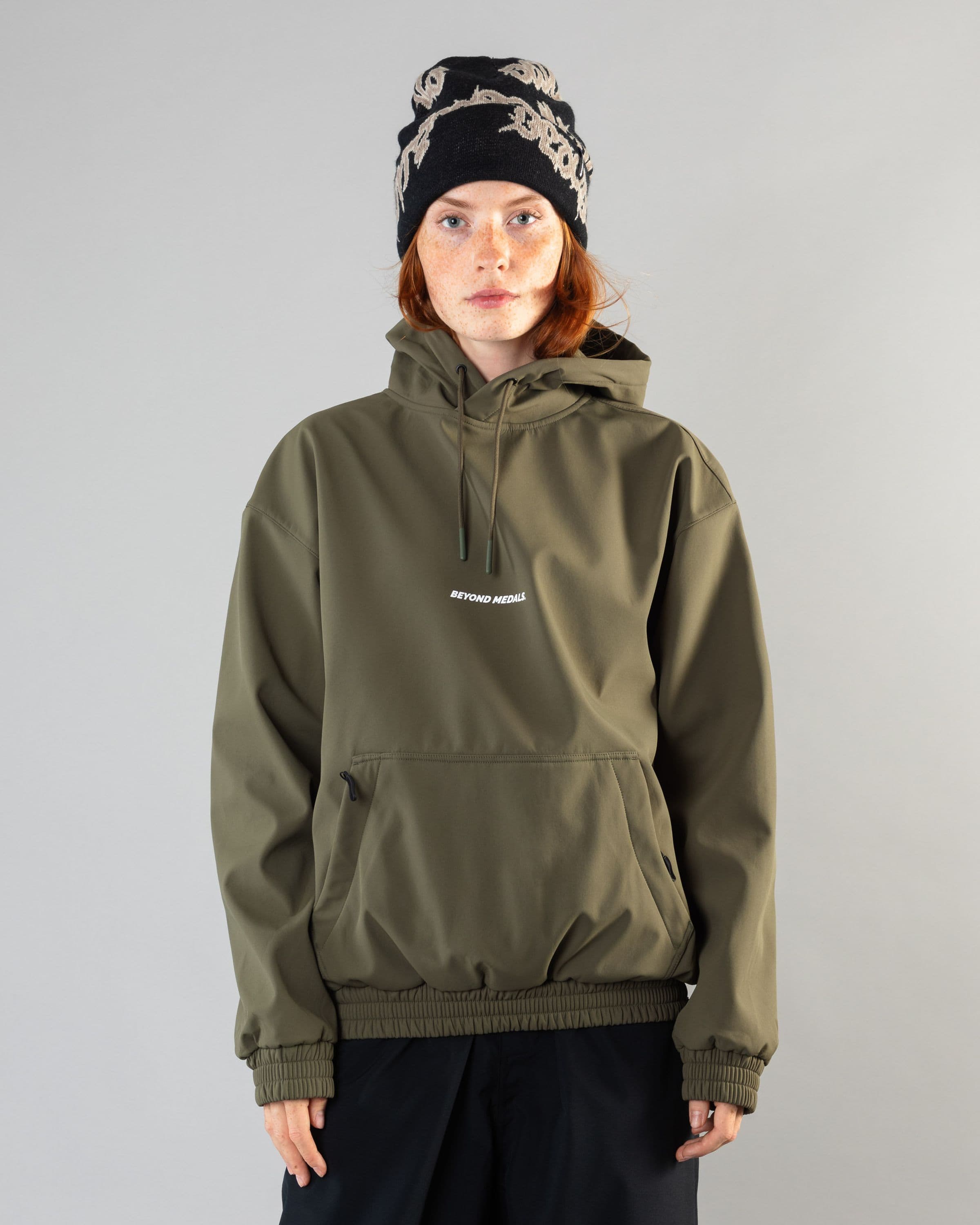 Outerwear clothing, softshell hoodie in green worn by model, Beyond Medals, 2024, front