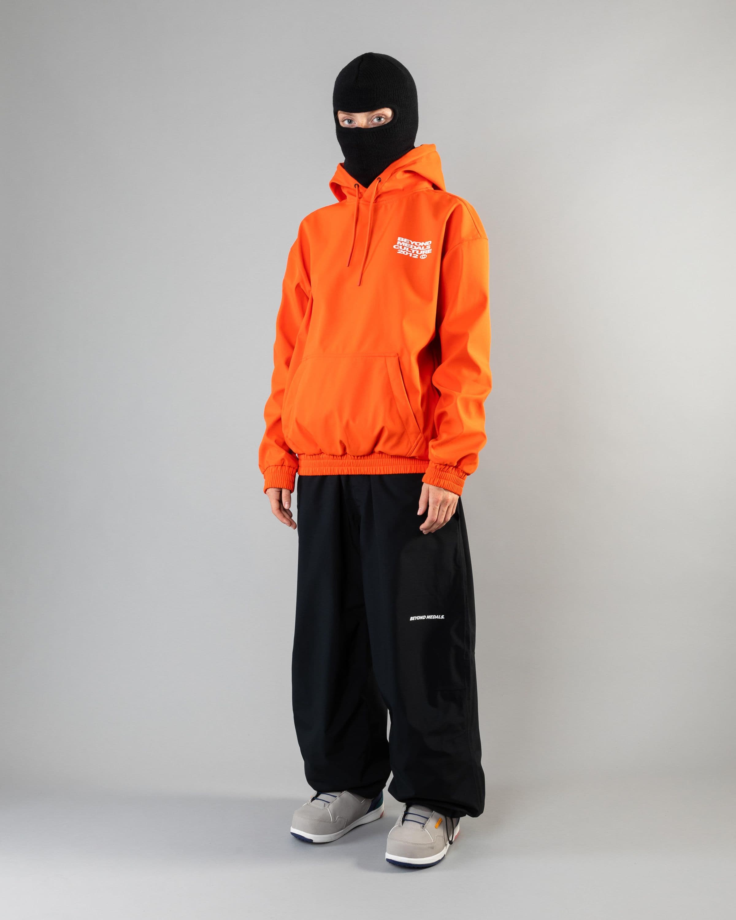 Outerwear clothing, softshell hoodie in orange worn by model, Beyond Medals, 2024, full front