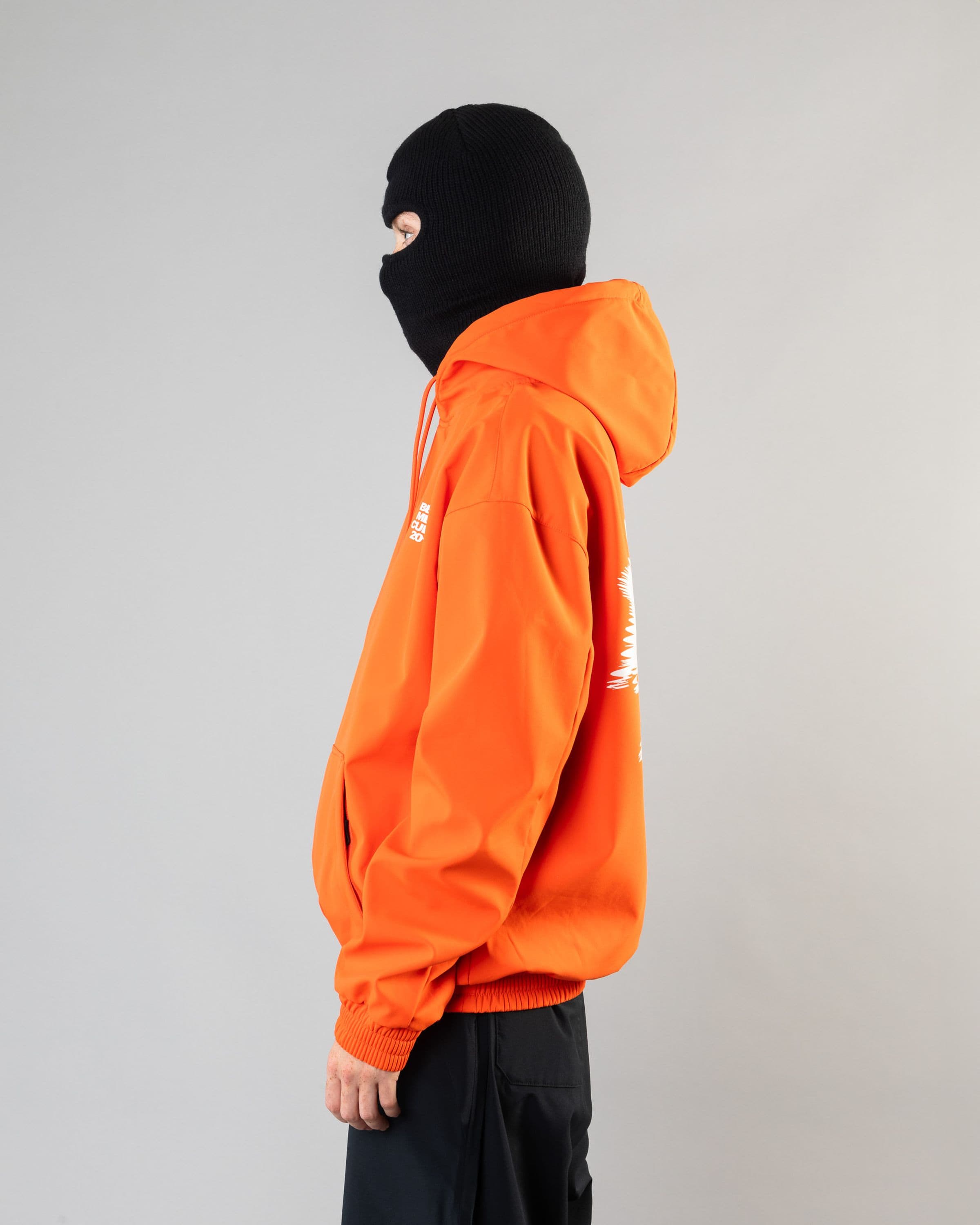 Outerwear clothing, softshell hoodie in orange worn by model, Beyond Medals, 2024, side