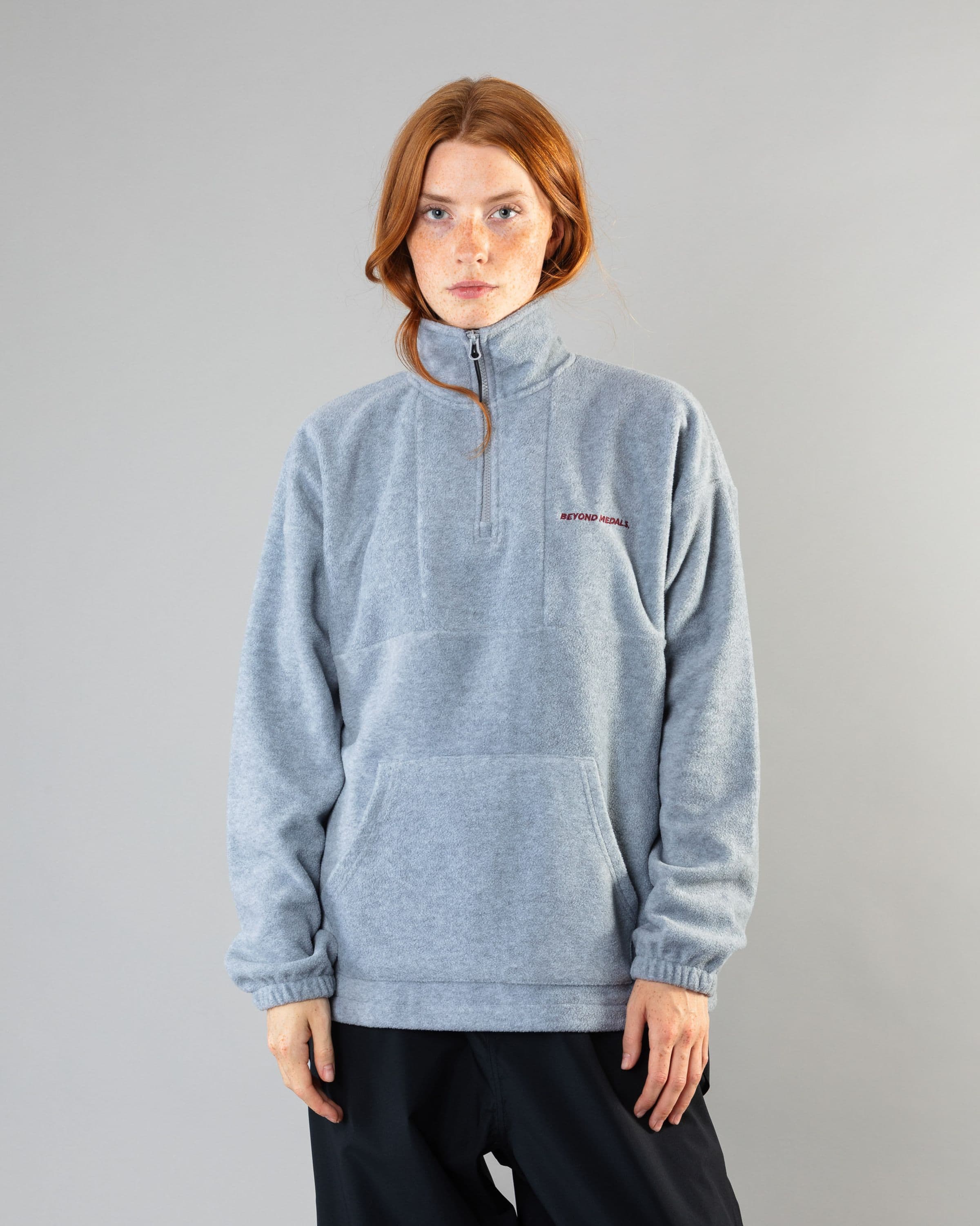 Streetwear clothing, halfzip fleece in grey worn by model, Beyond Medals, 2024, front