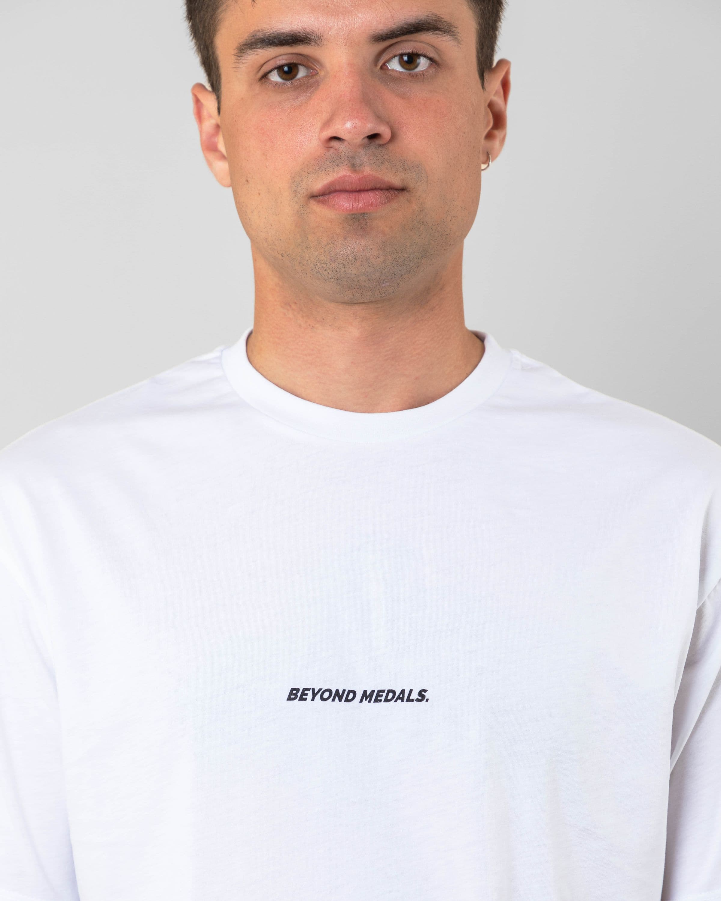 Streetwear clothing, baekkel tee in white worn by model, Beyond Medals, 2024 detail3