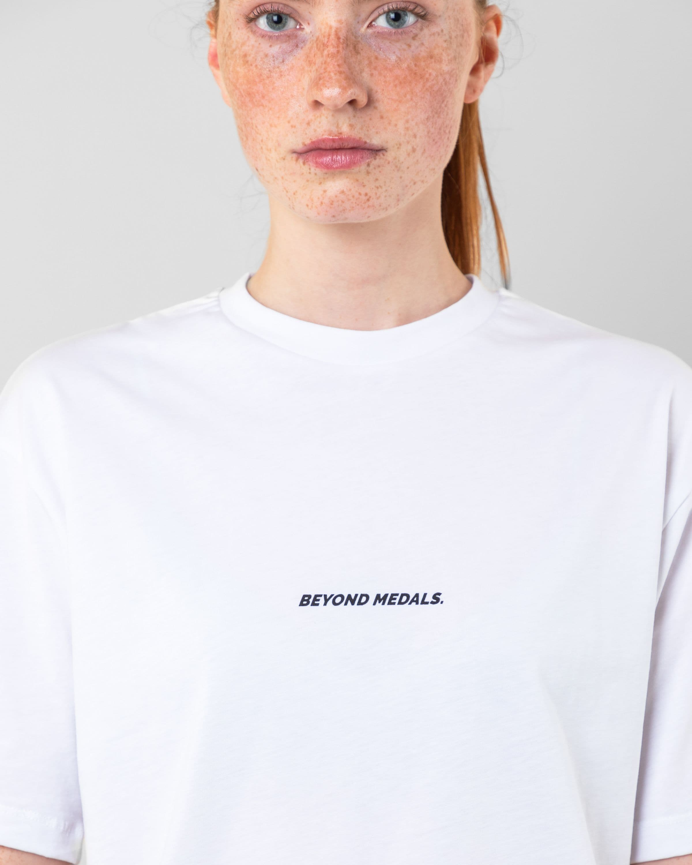 Streetwear clothing, baekkel tee in white worn by model, Beyond Medals, 2024 detail