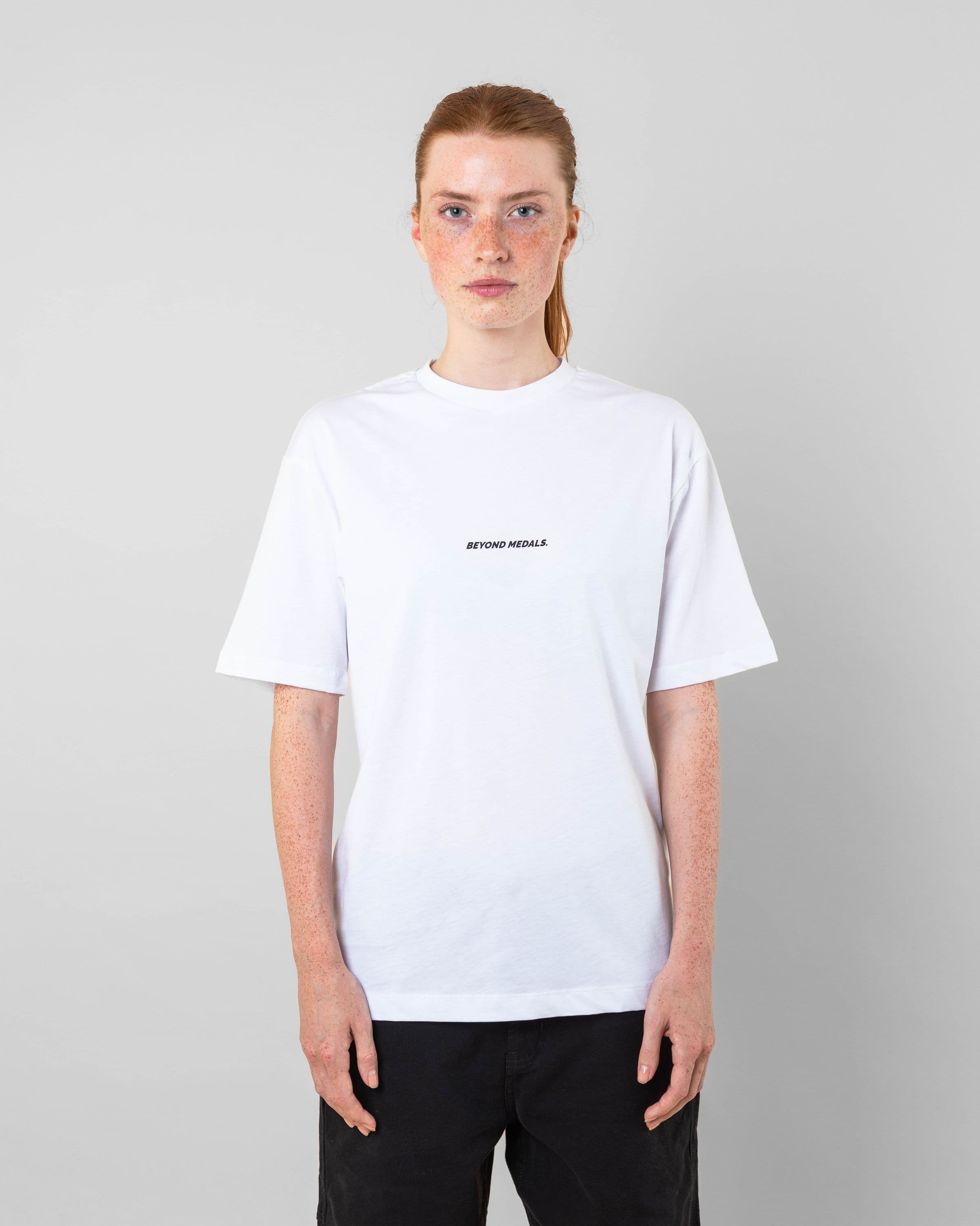 Streetwear clothing, baekkel tee in white worn by model, Beyond Medals, 2024 front