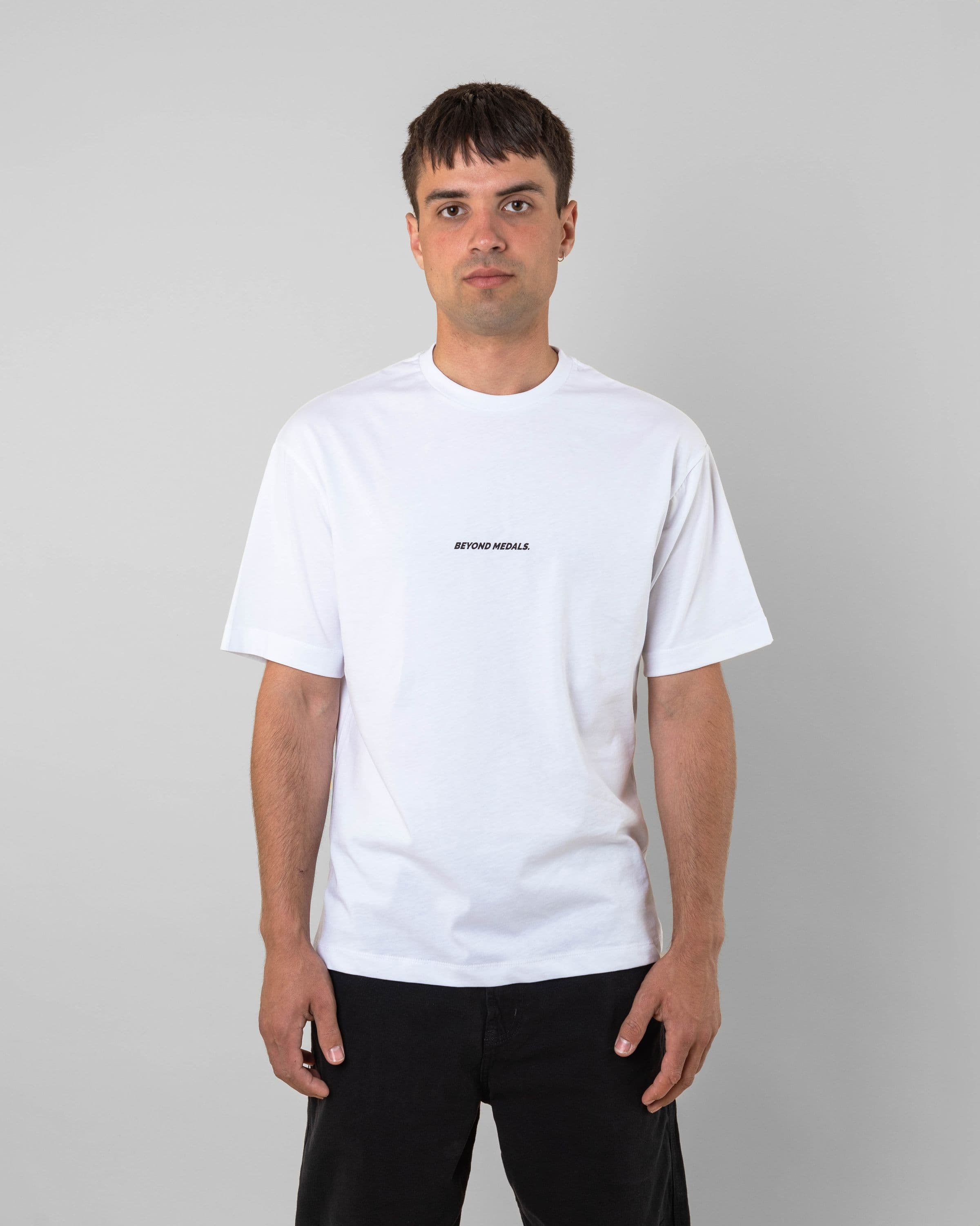 Streetwear clothing, baekkel tee in white worn by model, Beyond Medals, 2024 front2