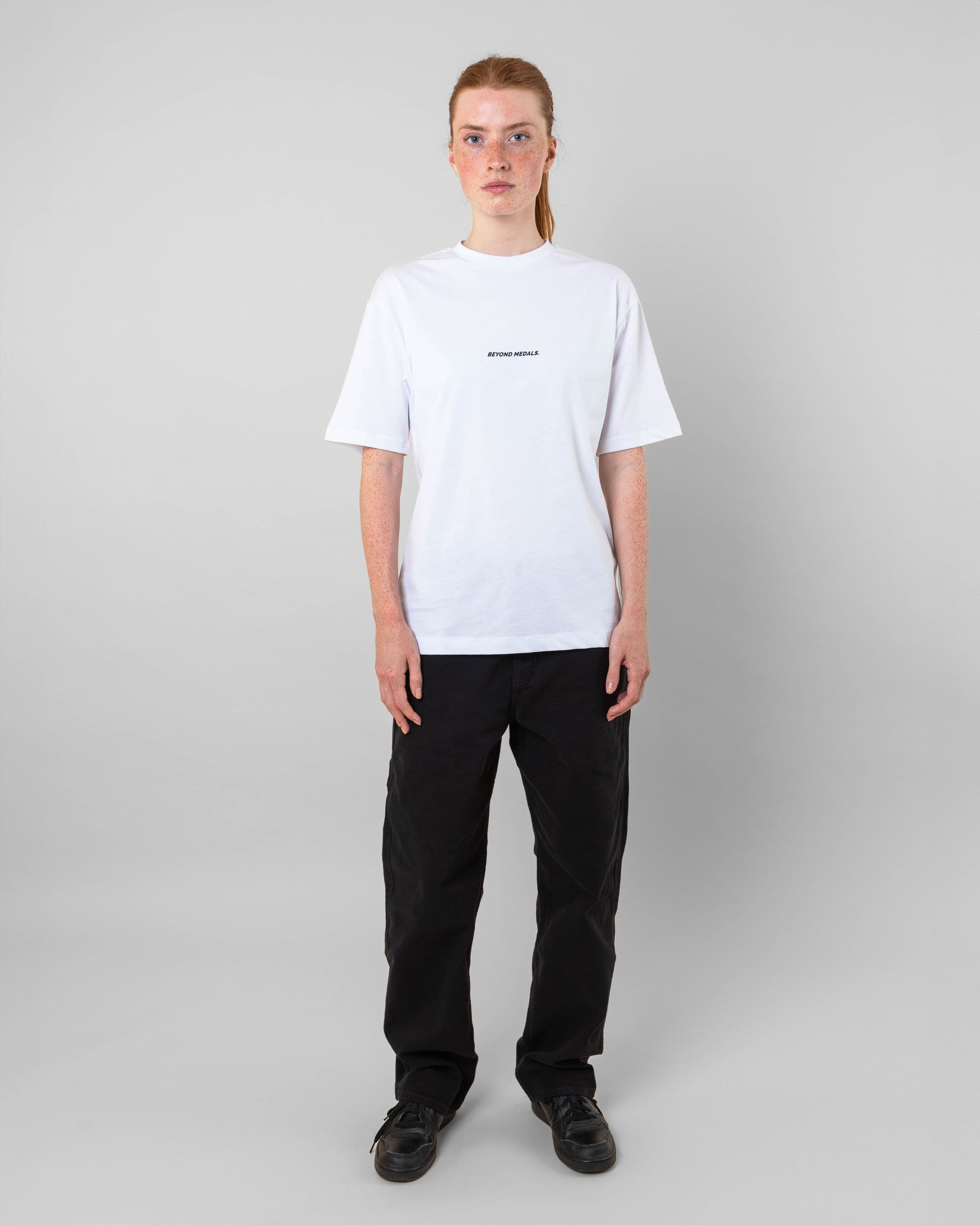Streetwear clothing, baekkel tee in white worn by model, Beyond Medals, 2024 full front