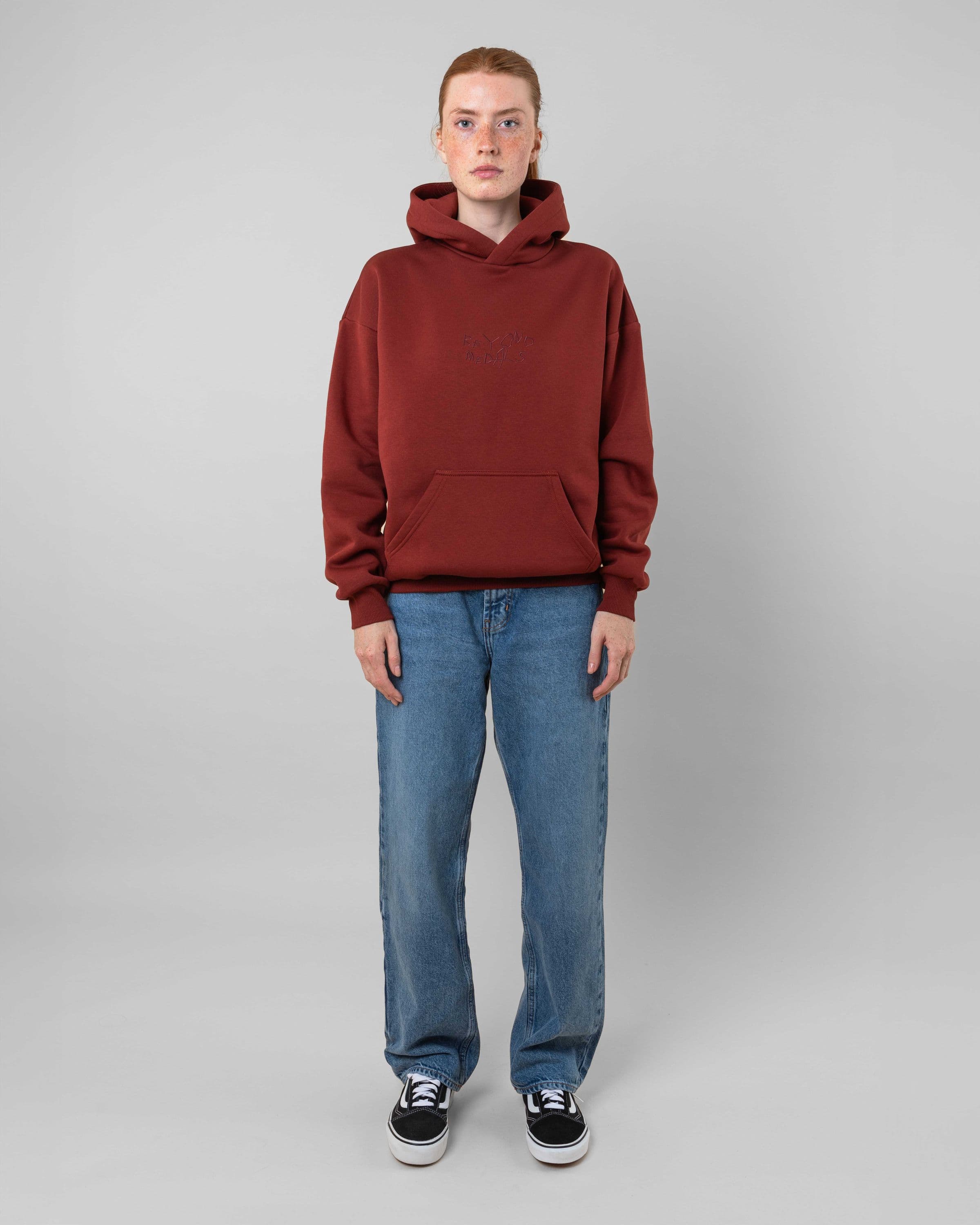 Streetwear clothing, angel hoodie 2.0 in red worn by model, Beyond Medals, 2024, full front