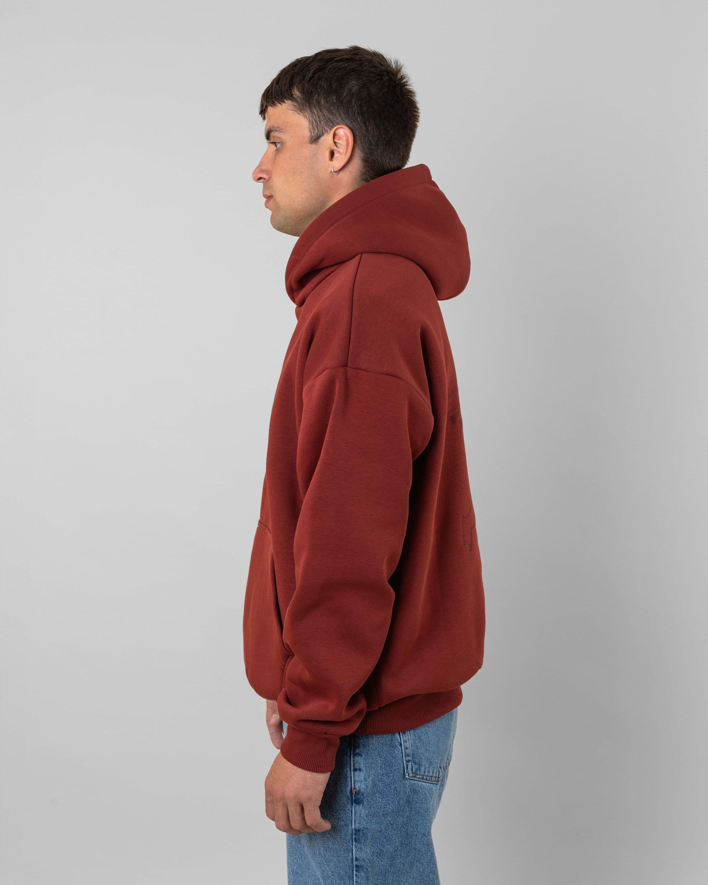 Streetwear clothing, angel hoodie 2.0 in red worn by model, Beyond Medals, 2024, side1