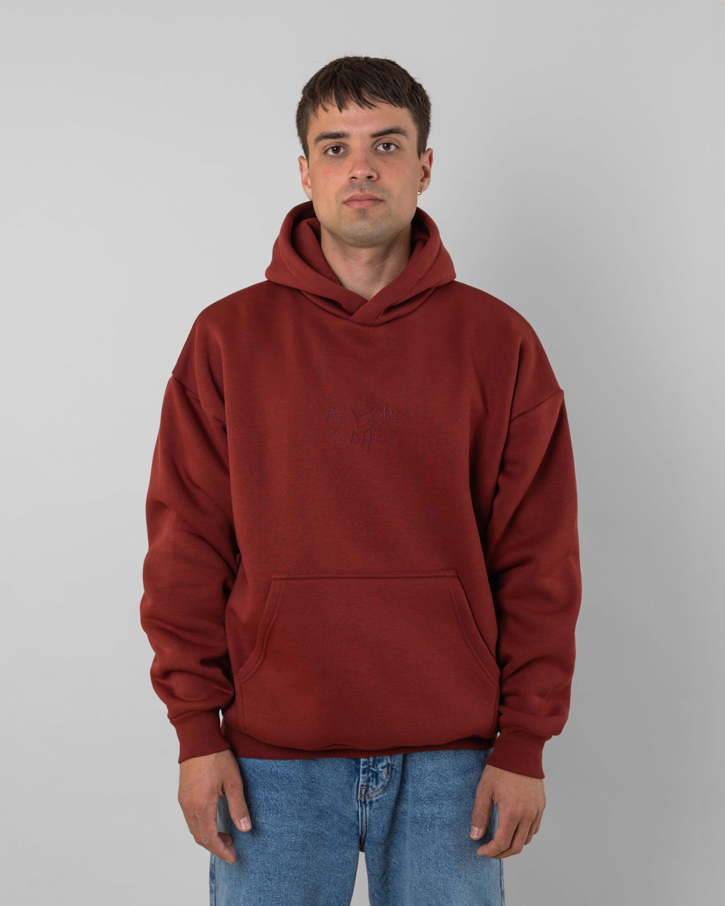Streetwear clothing, angel hoodie 2.0 in red worn by model, Beyond Medals, 2024, front1