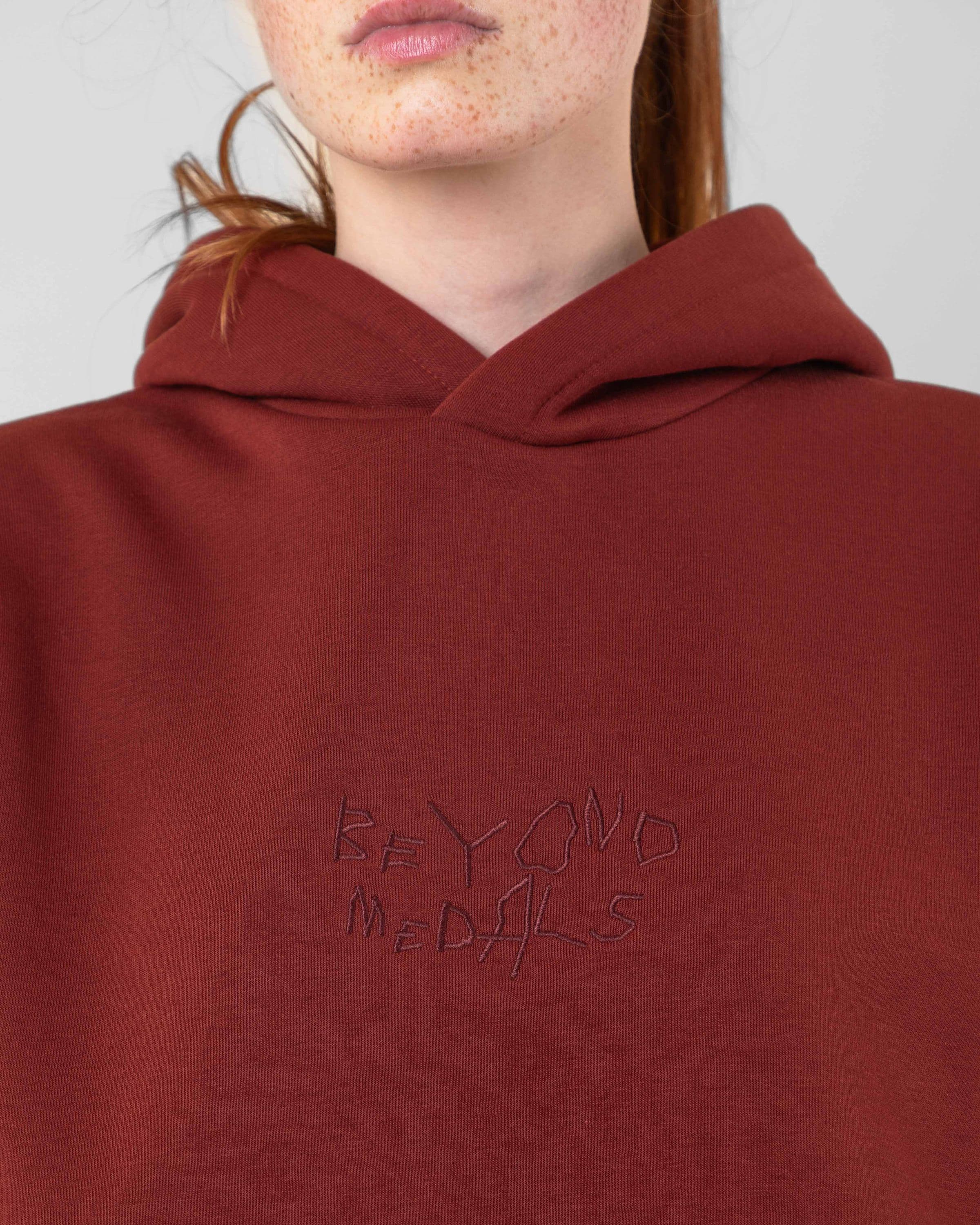 Streetwear clothing, angel hoodie 2.0 in red worn by model, Beyond Medals, 2024, detail