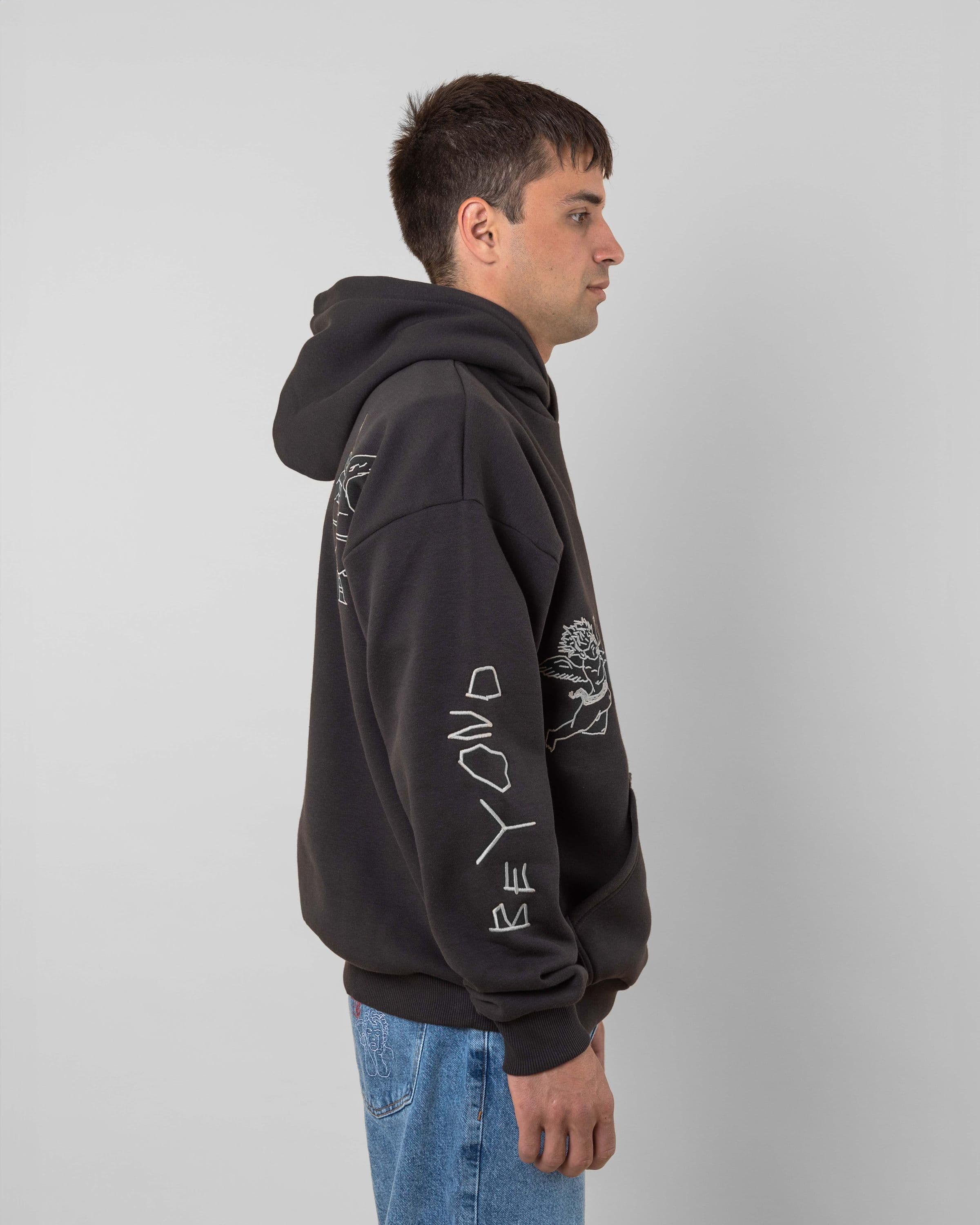 Streetwear clothing, angel hoodie 2.0 in grey worn by model, Beyond Medals, 2024, side4