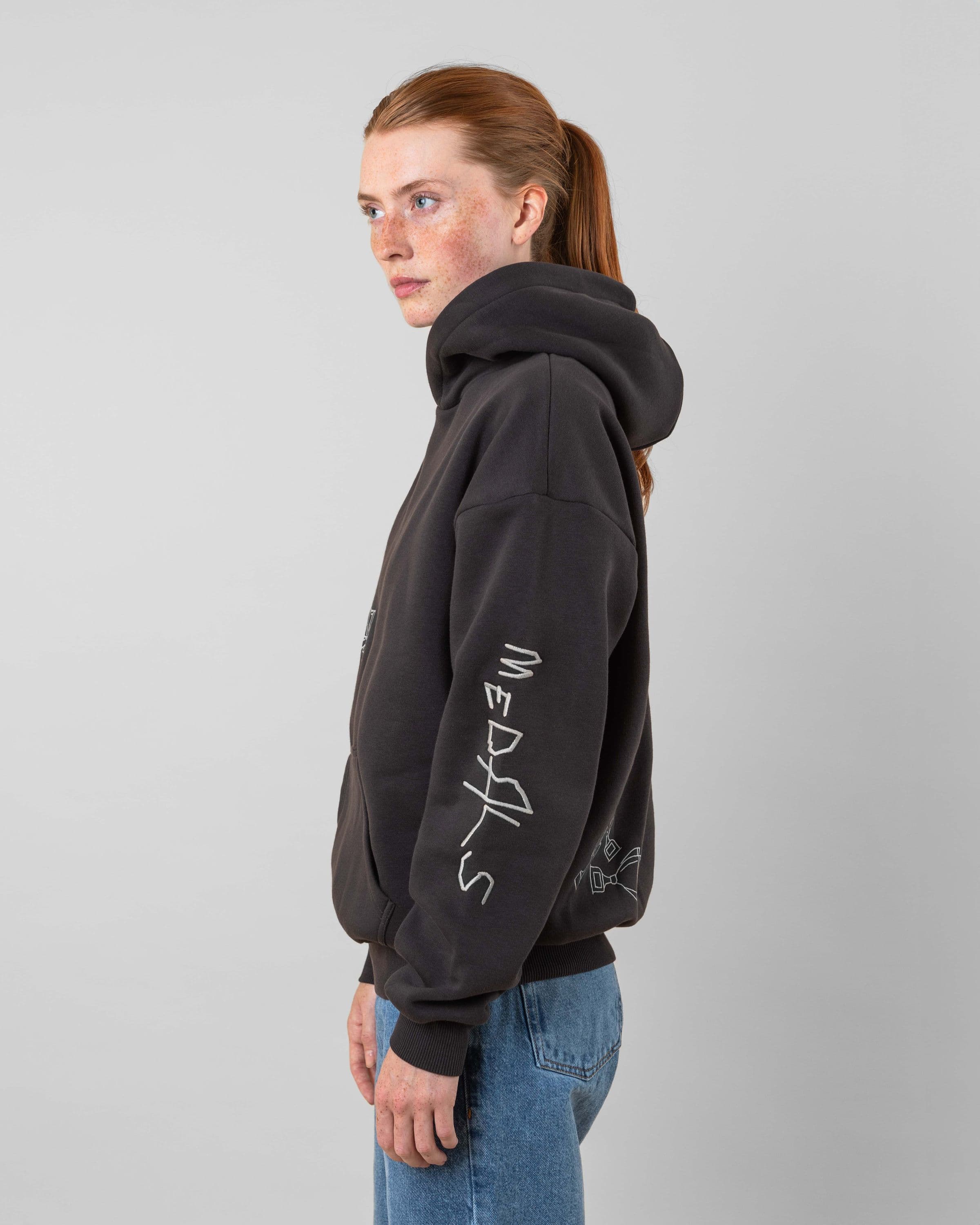 Streetwear clothing, angel hoodie 2.0 in grey worn by model, Beyond Medals, 2024, side2