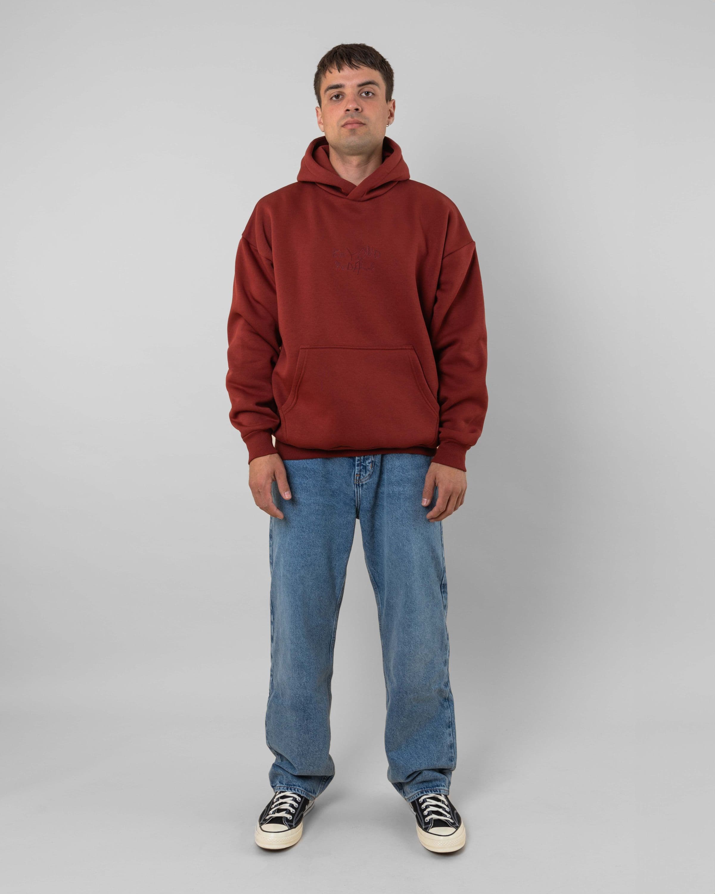 Streetwear clothing, angel hoodie 2.0 in red worn by model, Beyond Medals, 2024, full front1