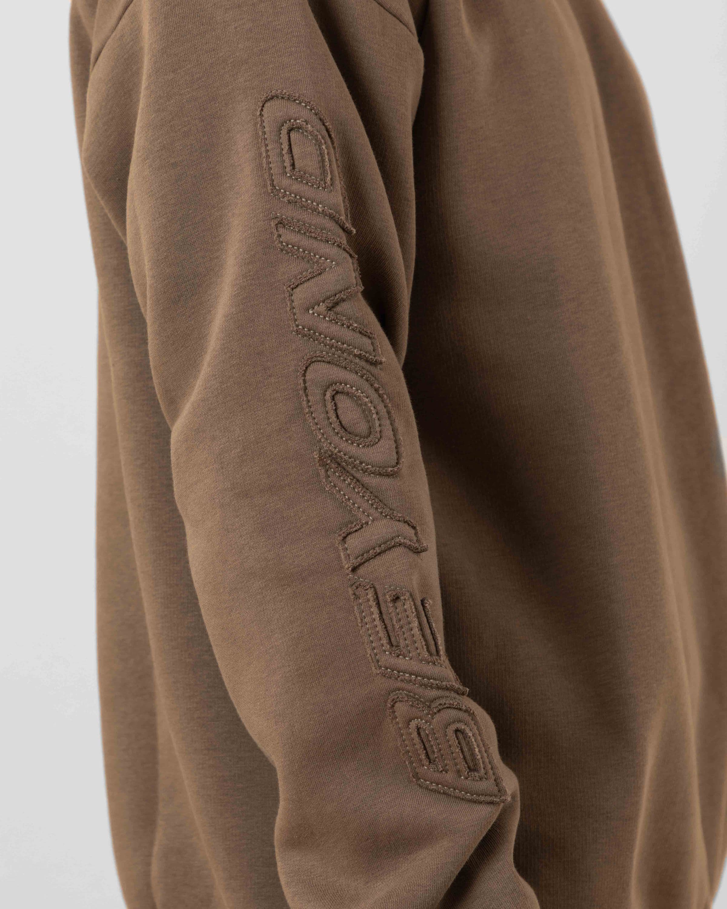 Streetwear clothing, incognito crewneck in brown worn by model, Beyond Medals, 2024, detail1