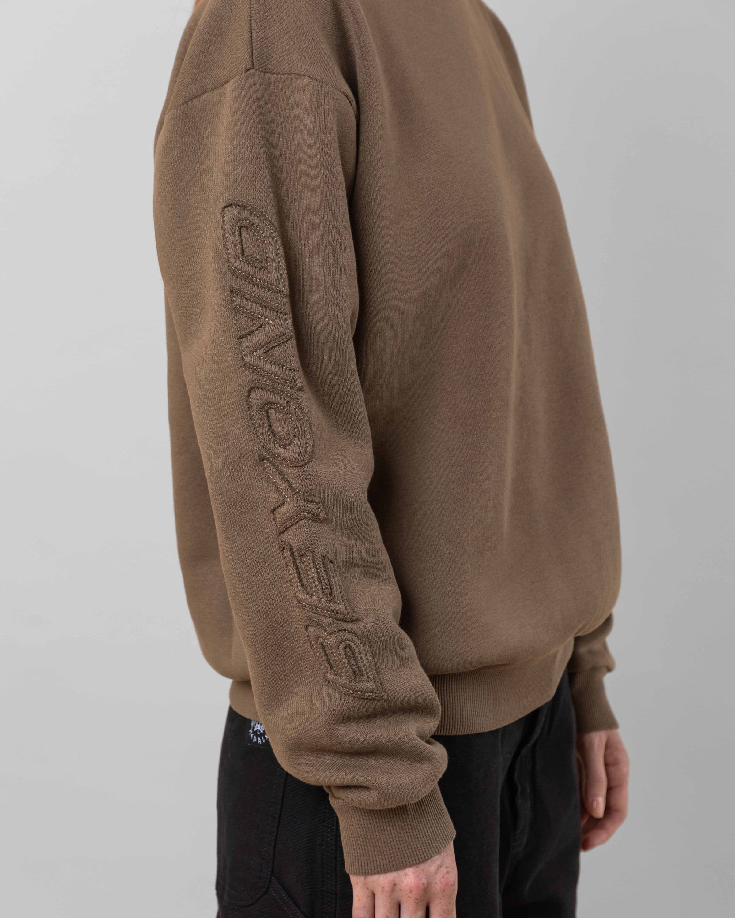 Streetwear clothing, incognito crewneck in brown worn by model, Beyond Medals, 2024, detail2