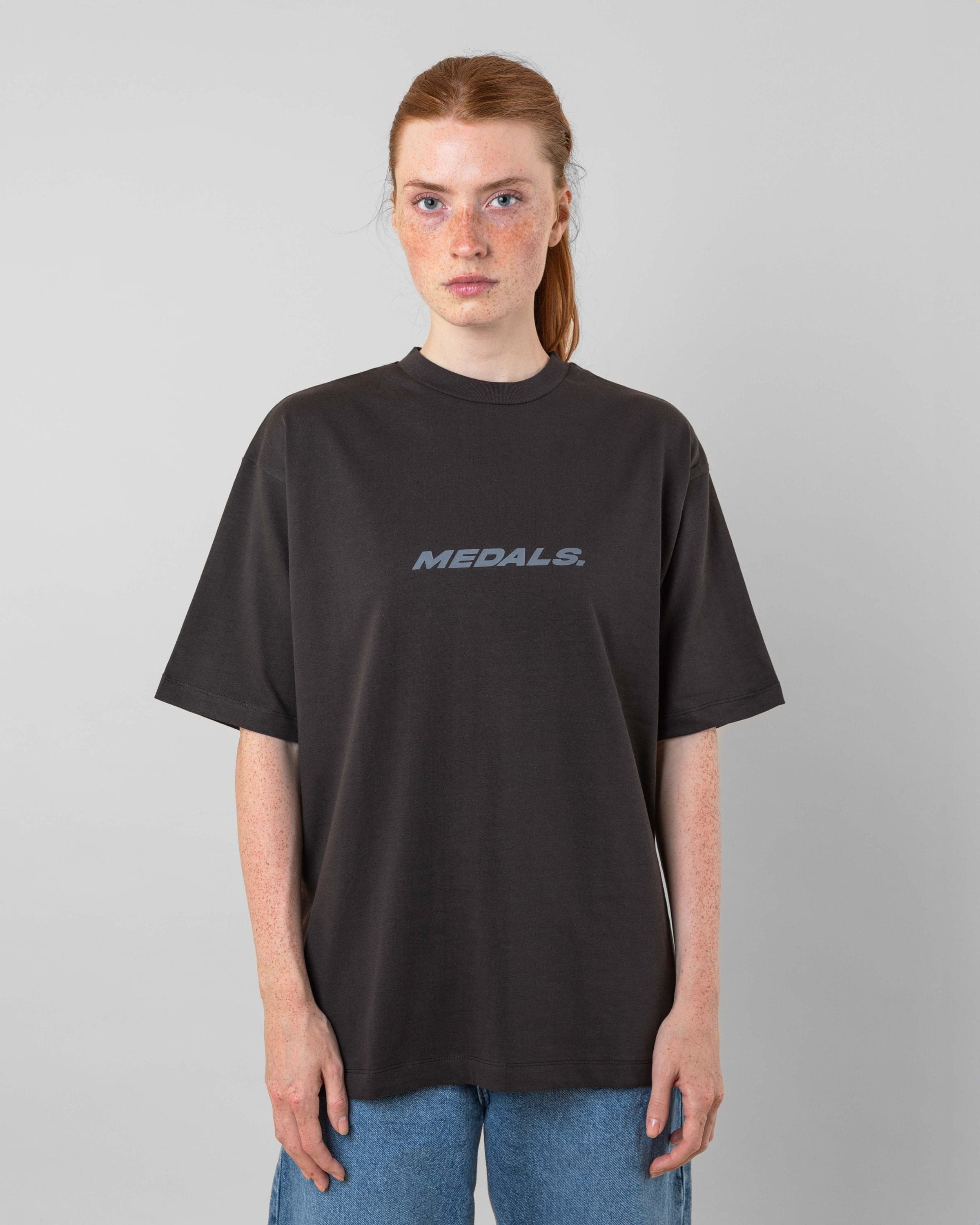 Streetwear clothing, medals tee in black worn by model, Beyond Medals, 2024, front