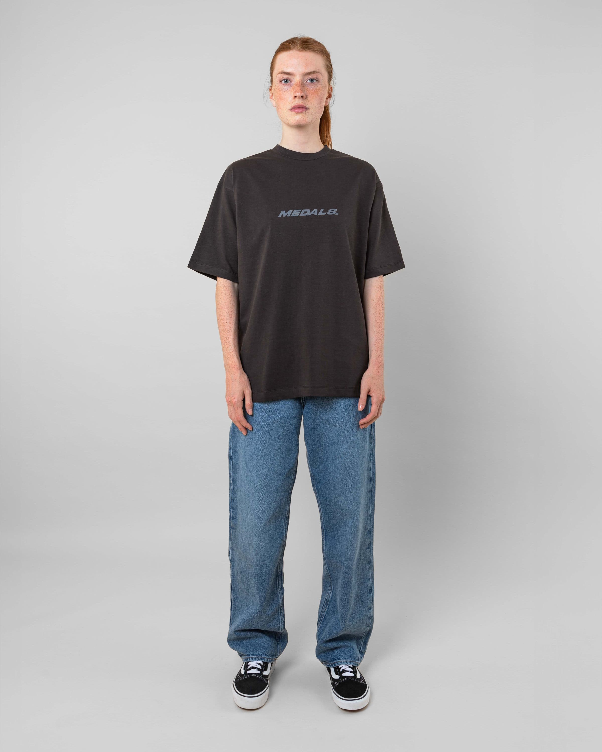 Streetwear clothing, medals tee in black worn by model, Beyond Medals, 2024, full front