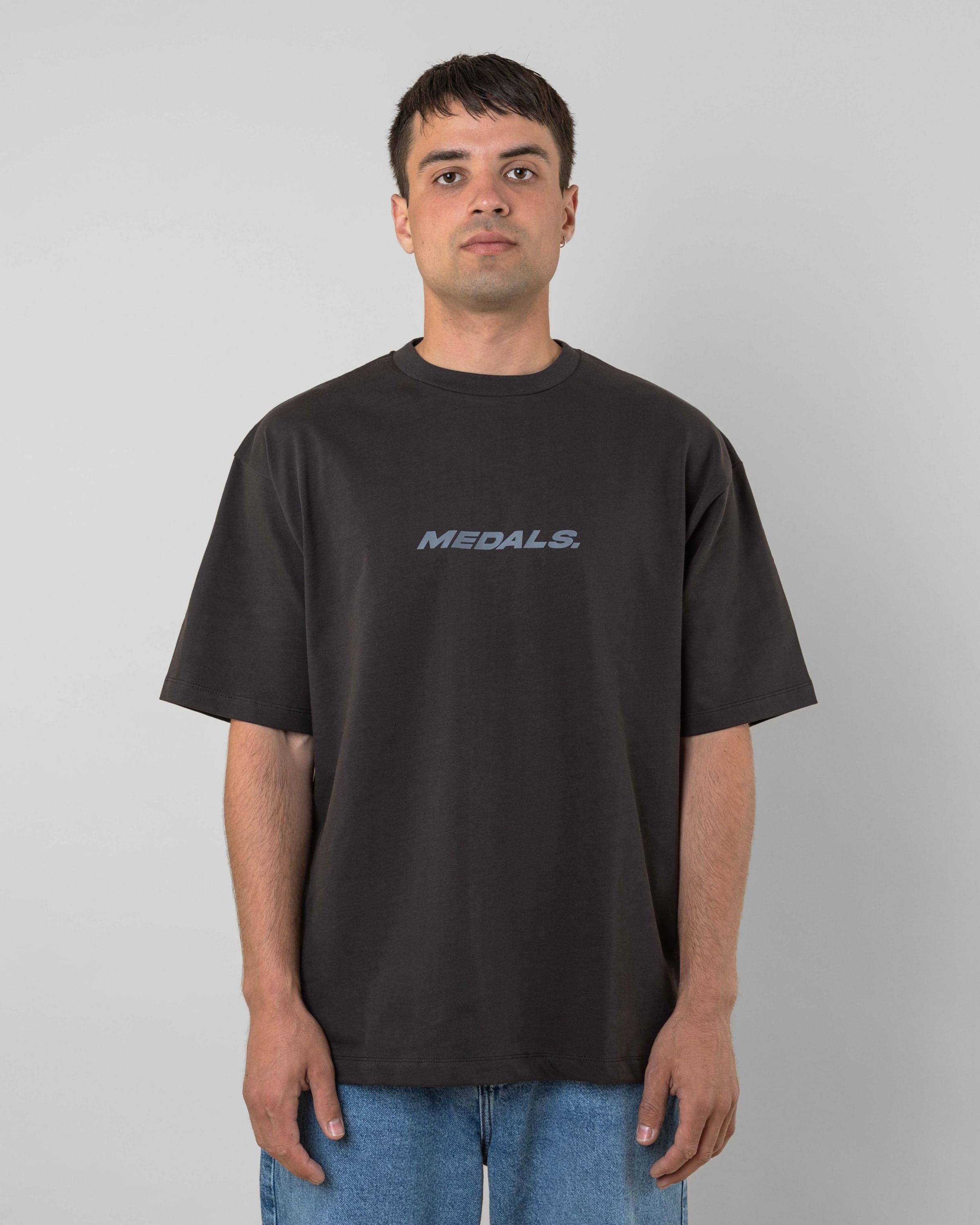 Streetwear clothing, medals tee in black worn by model, Beyond Medals, 2024, front1