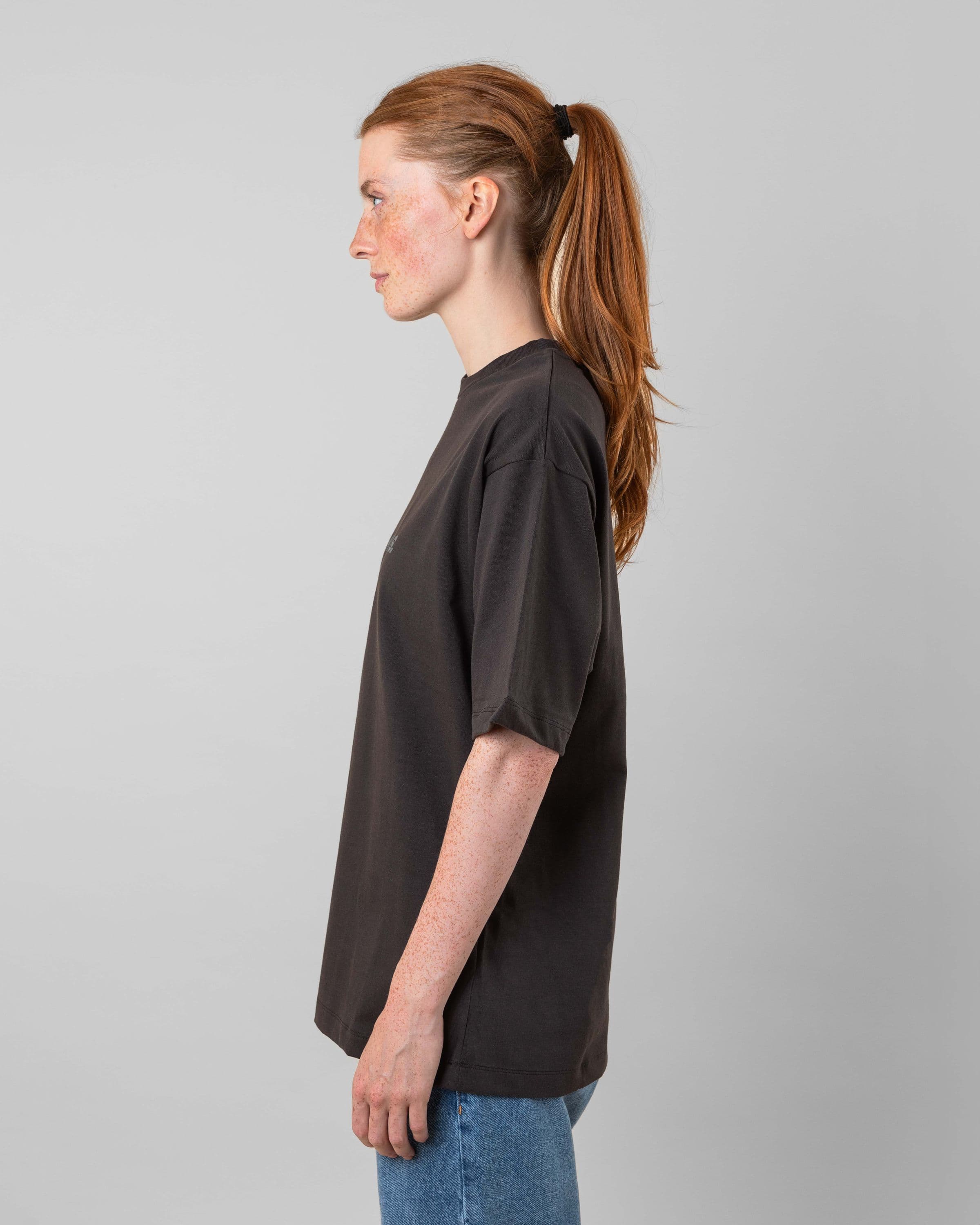 Streetwear clothing, medals tee in black worn by model, Beyond Medals, 2024, side