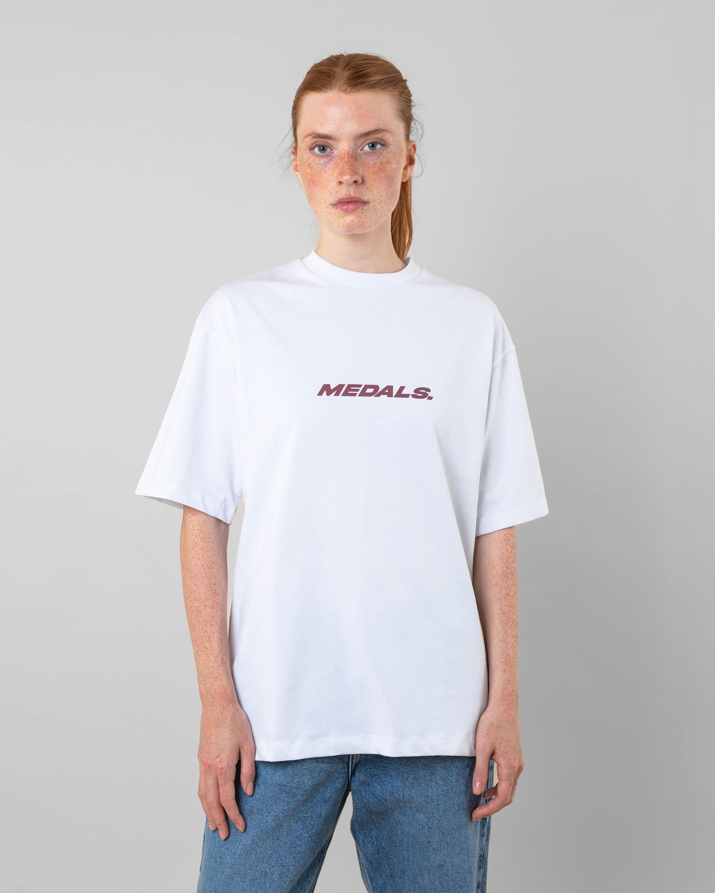 Streetwear clothing, medals tee in white worn by model, Beyond Medals, 2024, front