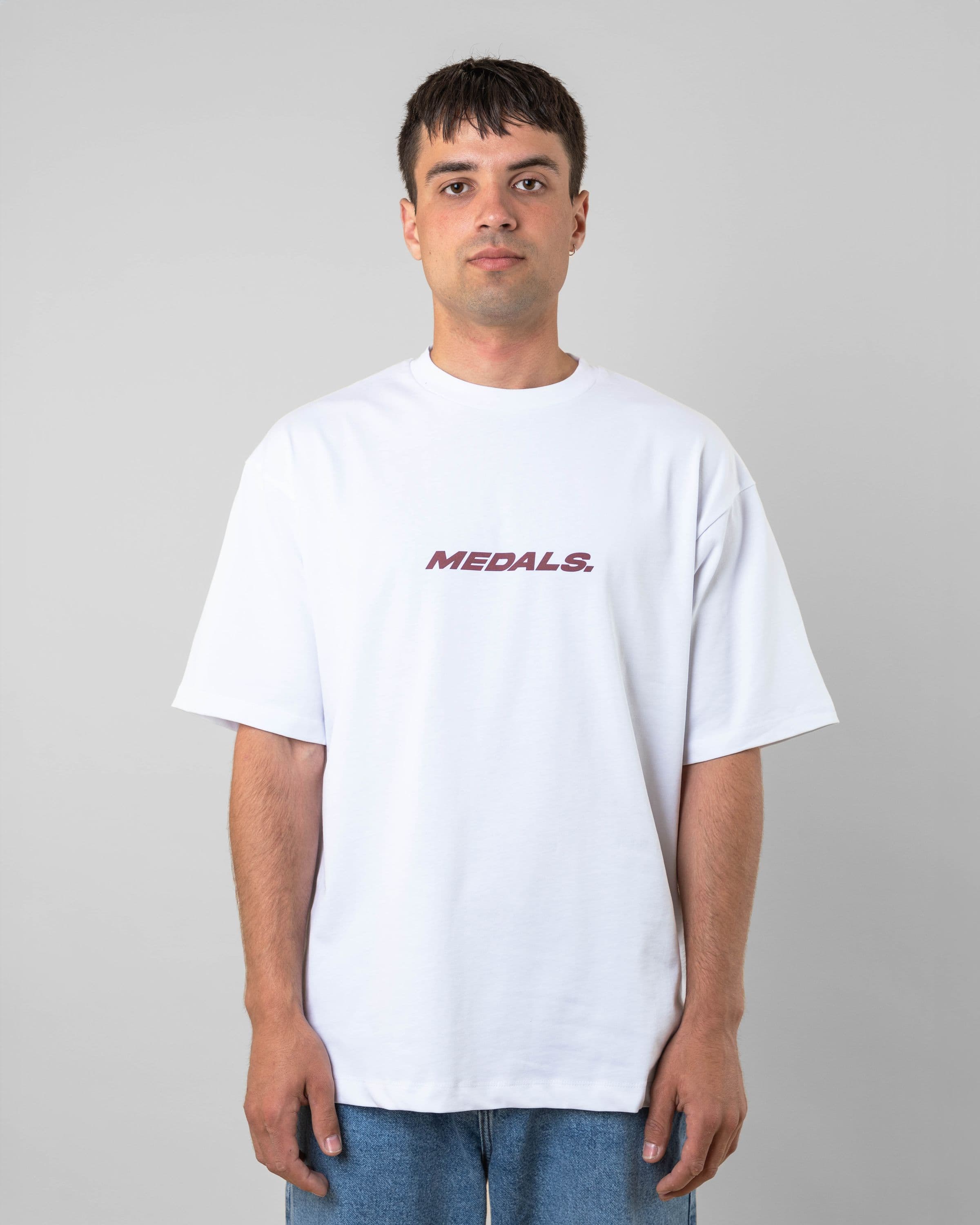 Streetwear clothing, medals tee in white worn by model, Beyond Medals, 2024, front1