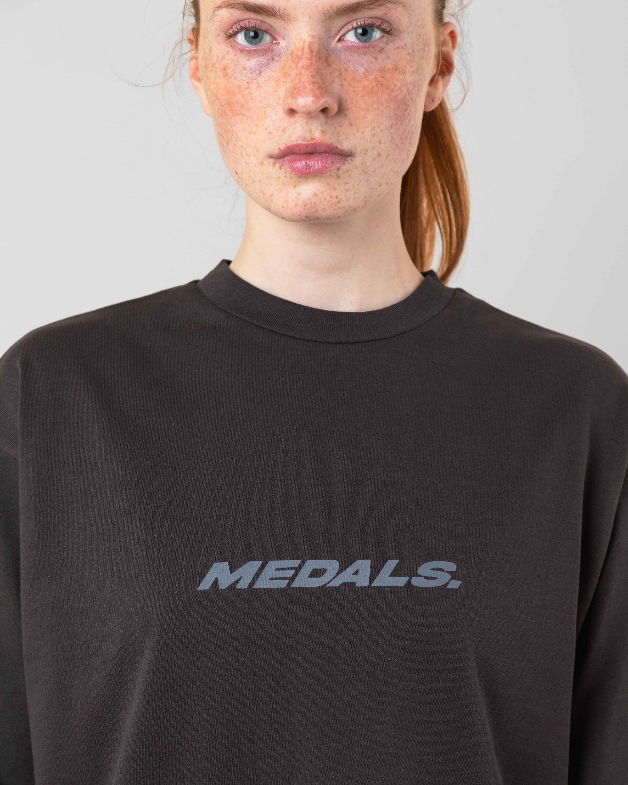 Streetwear clothing, medals tee in black worn by model, Beyond Medals, 2024, detail
