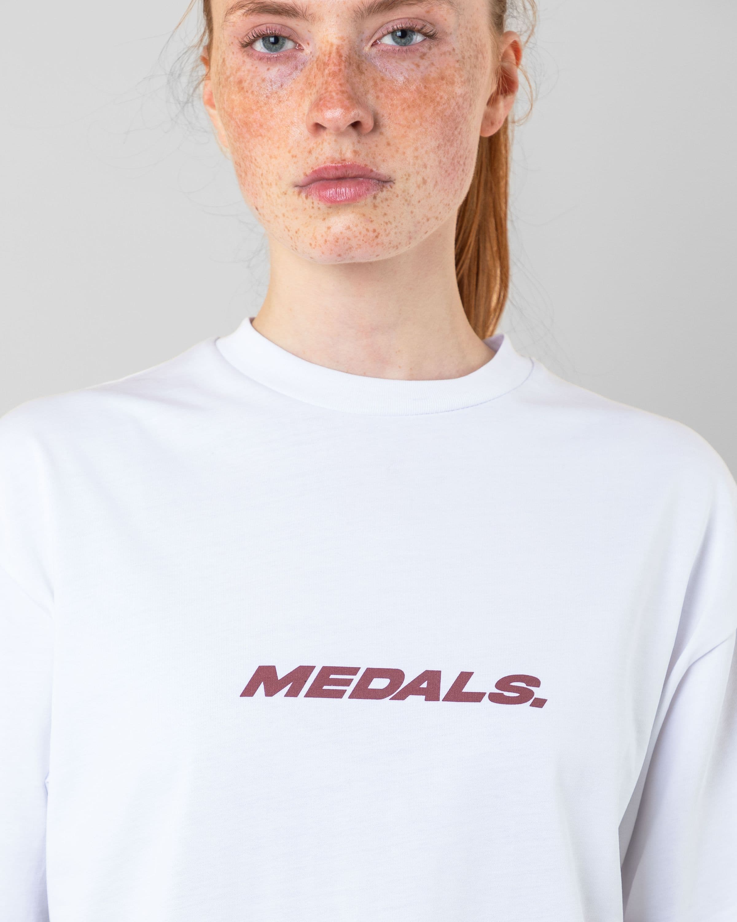 Streetwear clothing, medals tee in white worn by model, Beyond Medals, 2024, detail